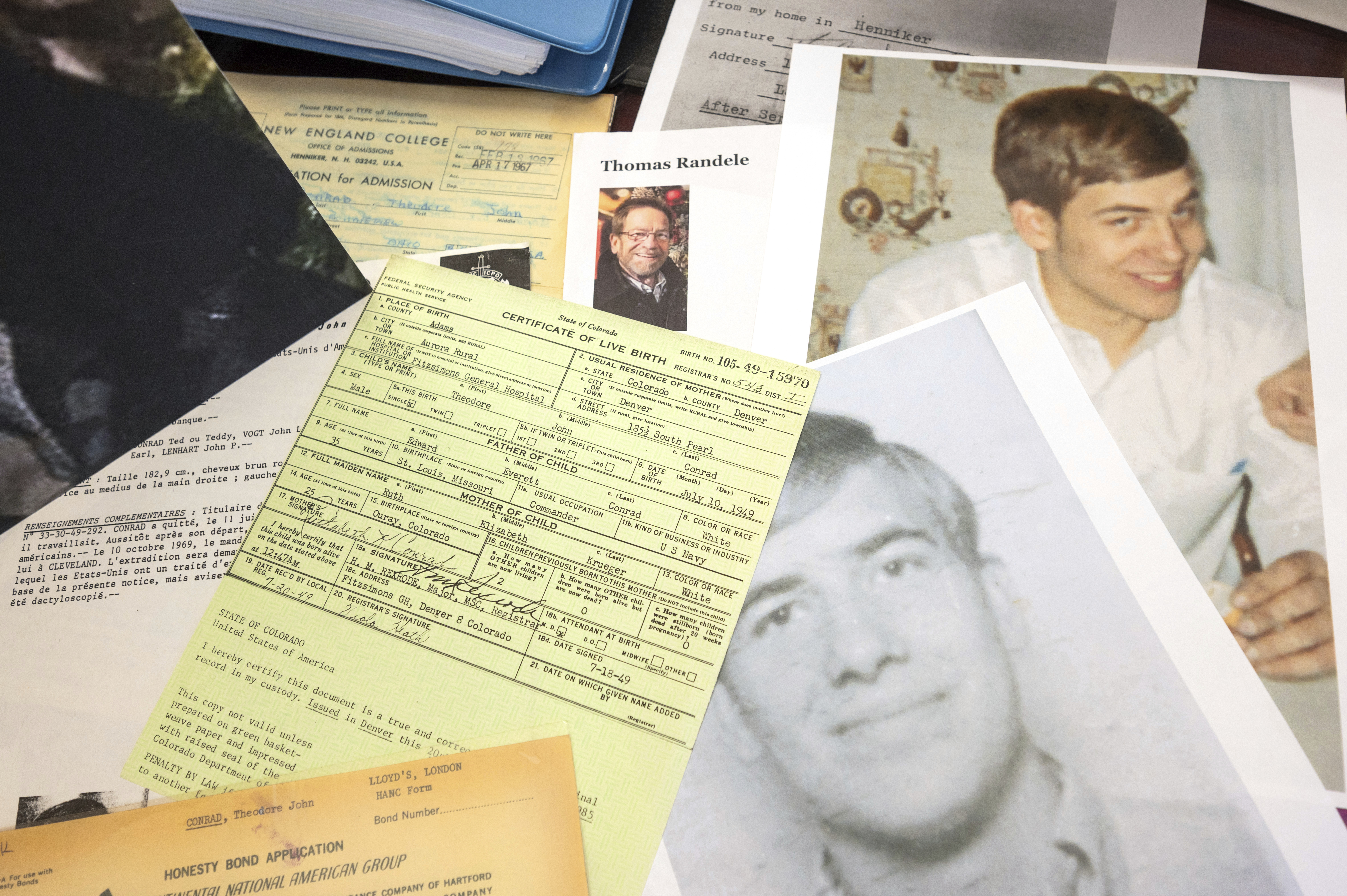 Photos, a driver's license, a death notice and other items from a 1969 robbery involving Ted Conrad are shown at a US Courthouse in Cleveland. 