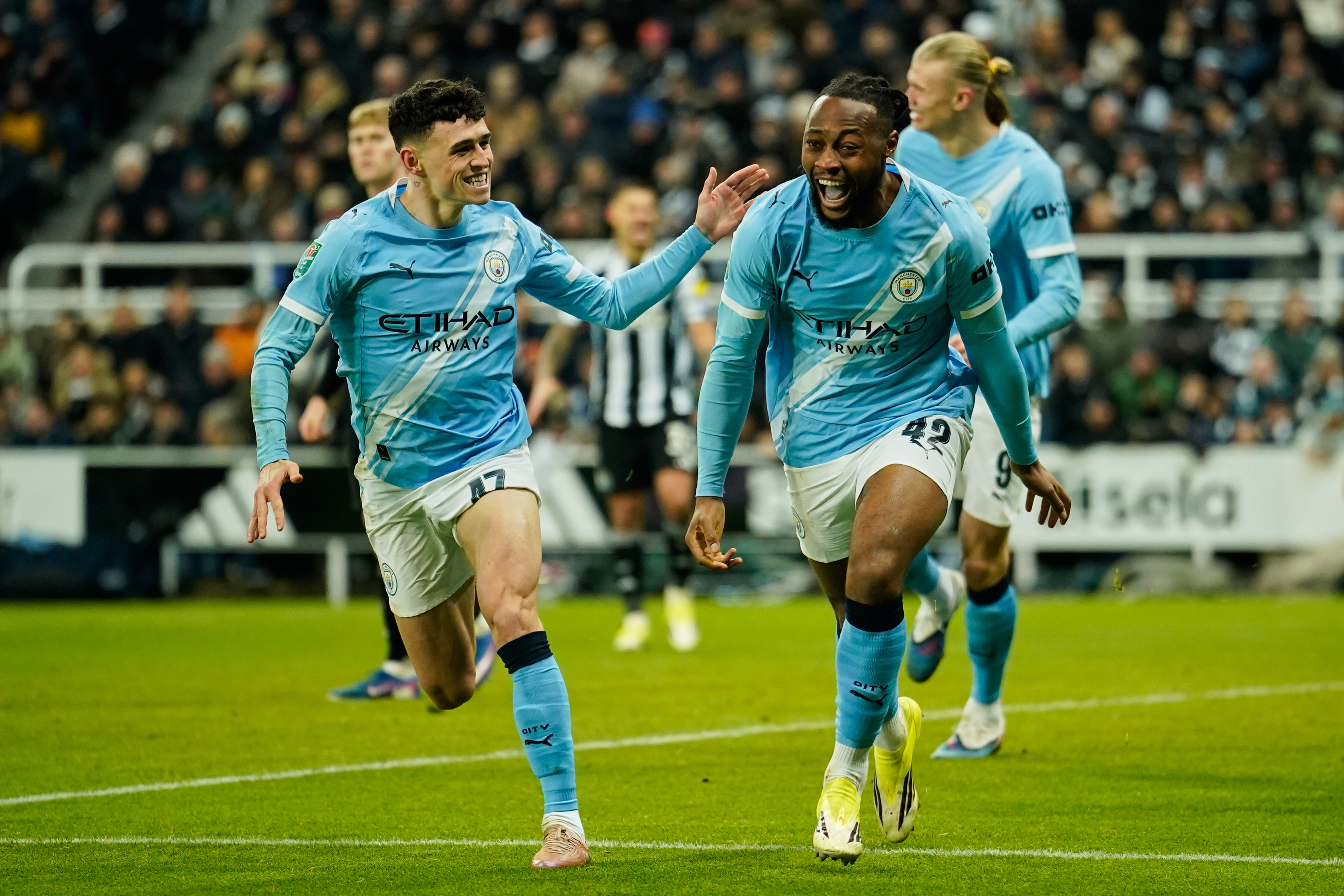 Manchester City's Antoine Semenyo, right, celebrates after scoring his side's opening goal during the English League Cup semi final.