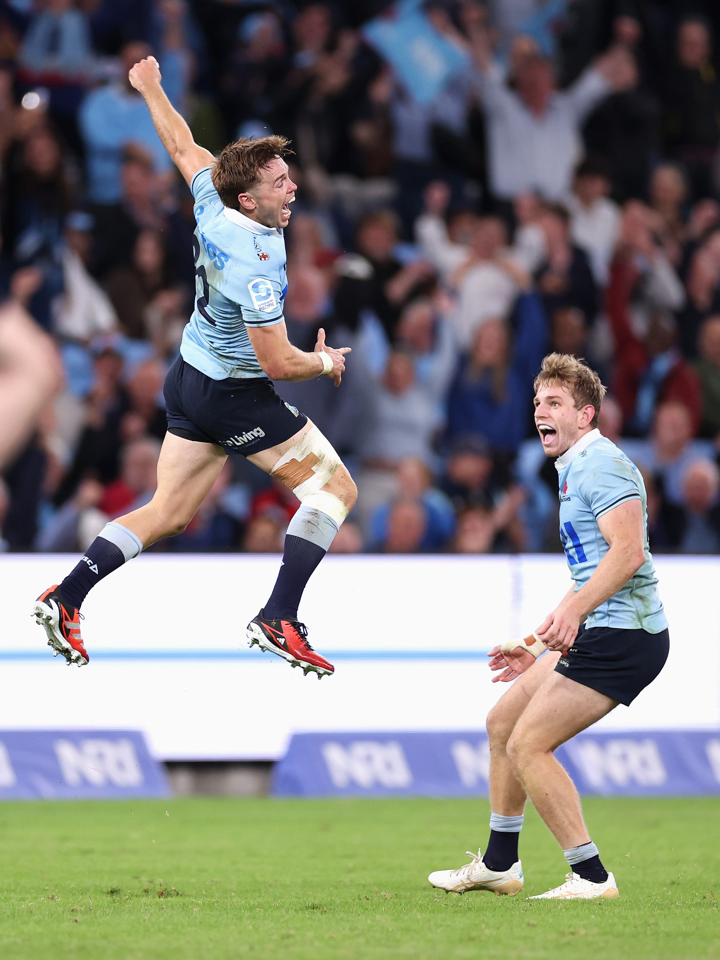 NSW's Will Harrison celebrates kicking the winning drop goal as Max Jorgensen watches on.