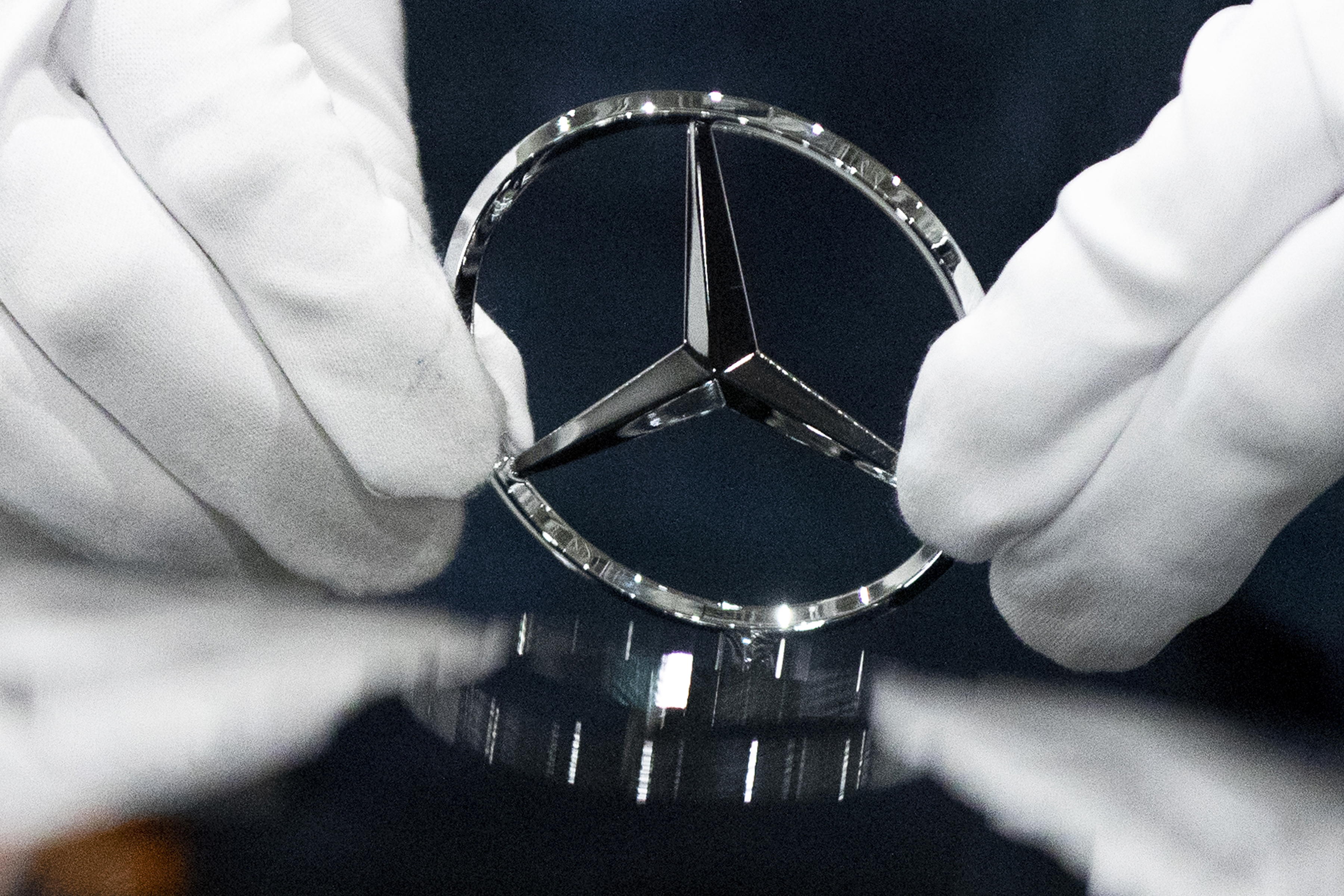  In this Wednesday, April 3, 2019 file photo, a worker wipes a logo of a car at the Mercedes Benz automobile assembly plant outside Moscow, Russia. German automaker Daimler on Friday dismissed a cease and desist demand from two environmental groups to commit to ending the sale of combustion engine vehicles by 2030. Lawyers for Greenpeace and the group Deutsche Umwelthilfe have threatened to sue Daimler, BMW and Volkswagen unless they sign a legal pledge not to put new gas-fueled vehicles o