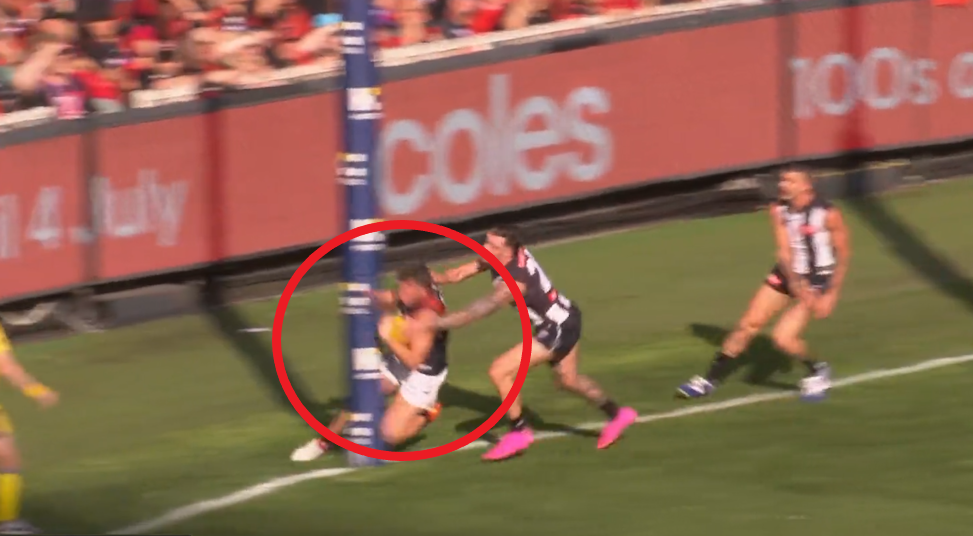 Essendon player Jye Menzie collided with the goalpost.