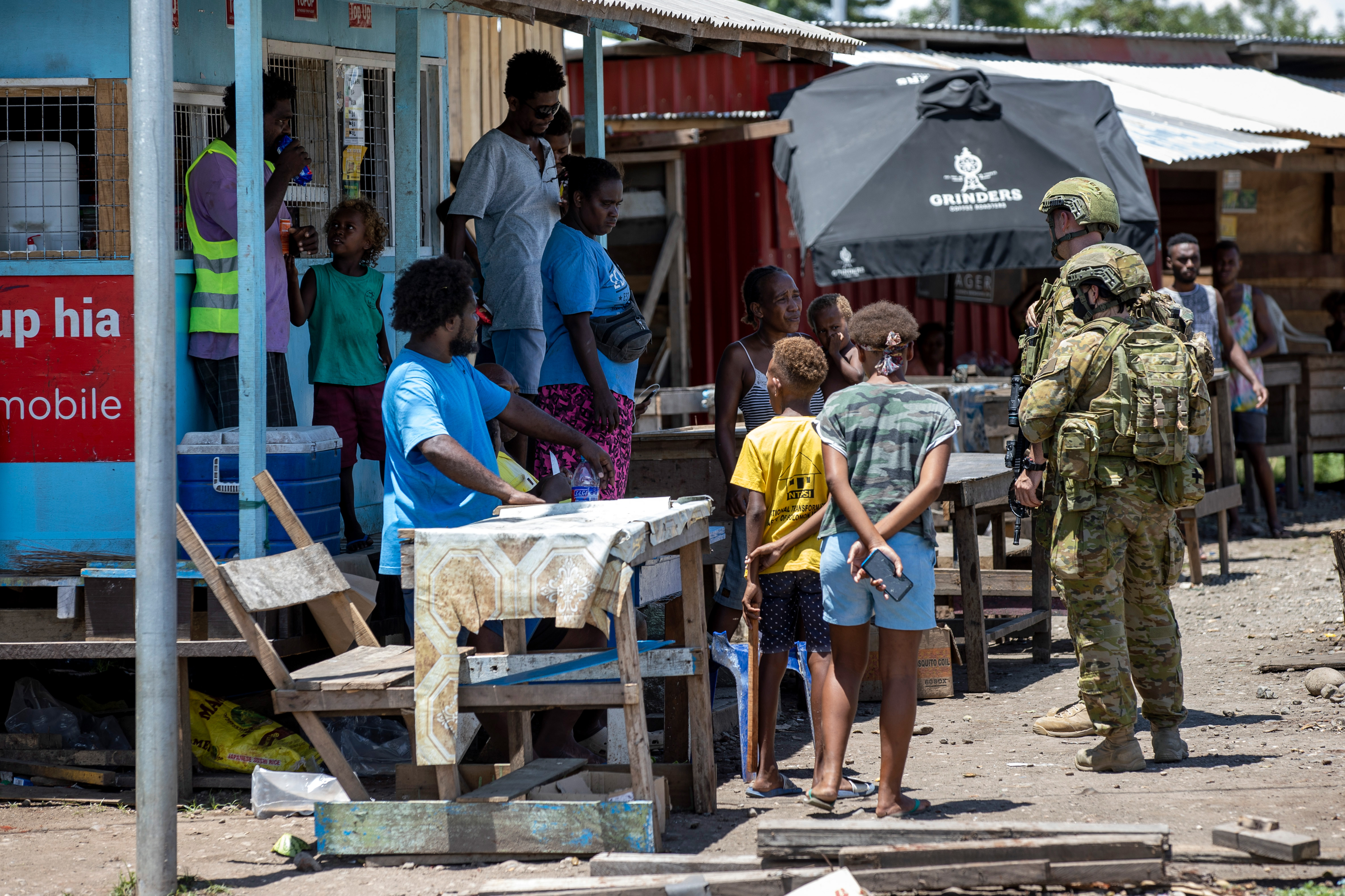 Australian Army soldiers talk with local citizens in Honiara, Solomon Islands