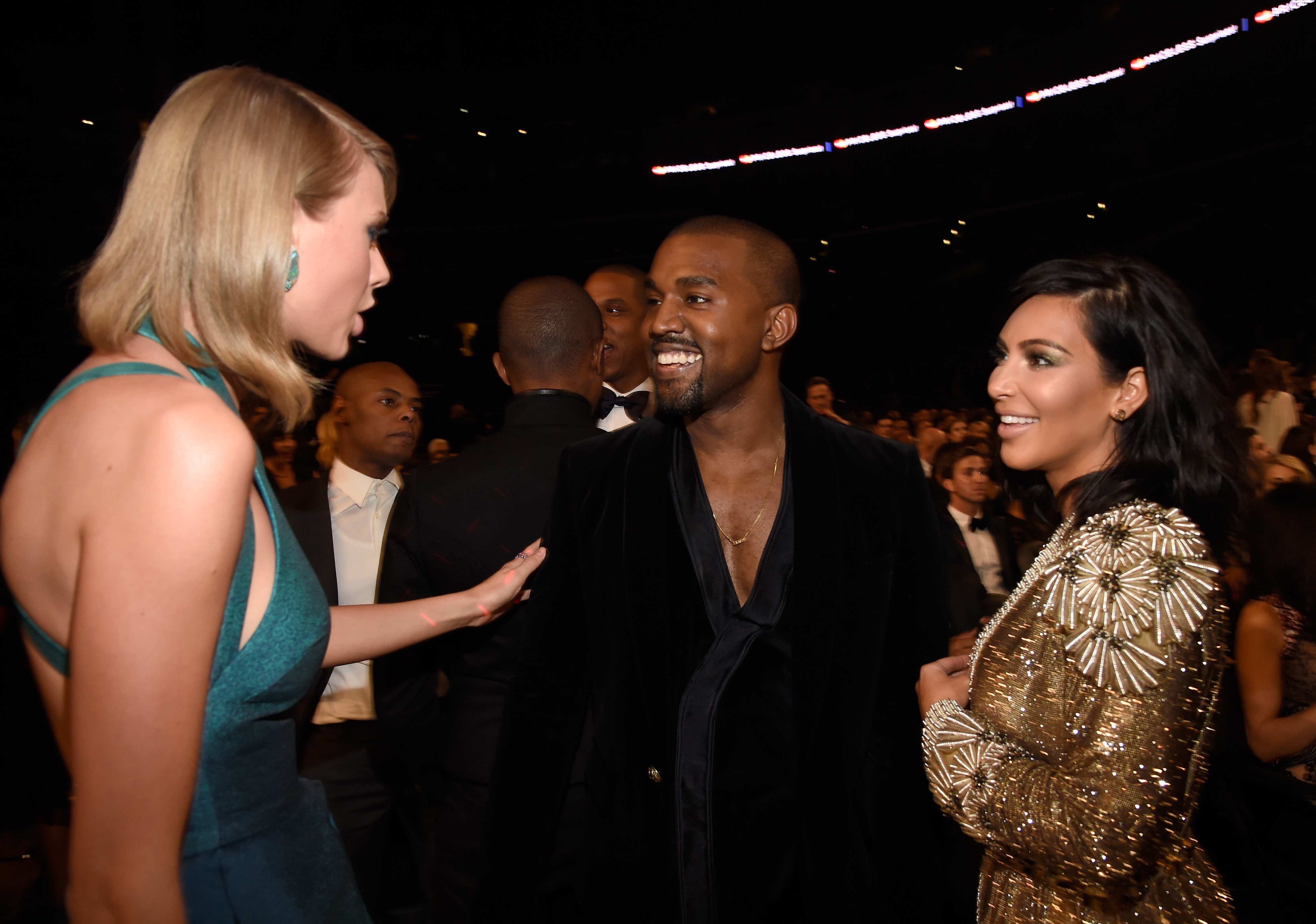 Kayne West, with then wife Kim Kardashian, and Taylor Swift at the 57th Annual GRAMMY Awards on February 8, 2015, where they made up six years after their feud. 