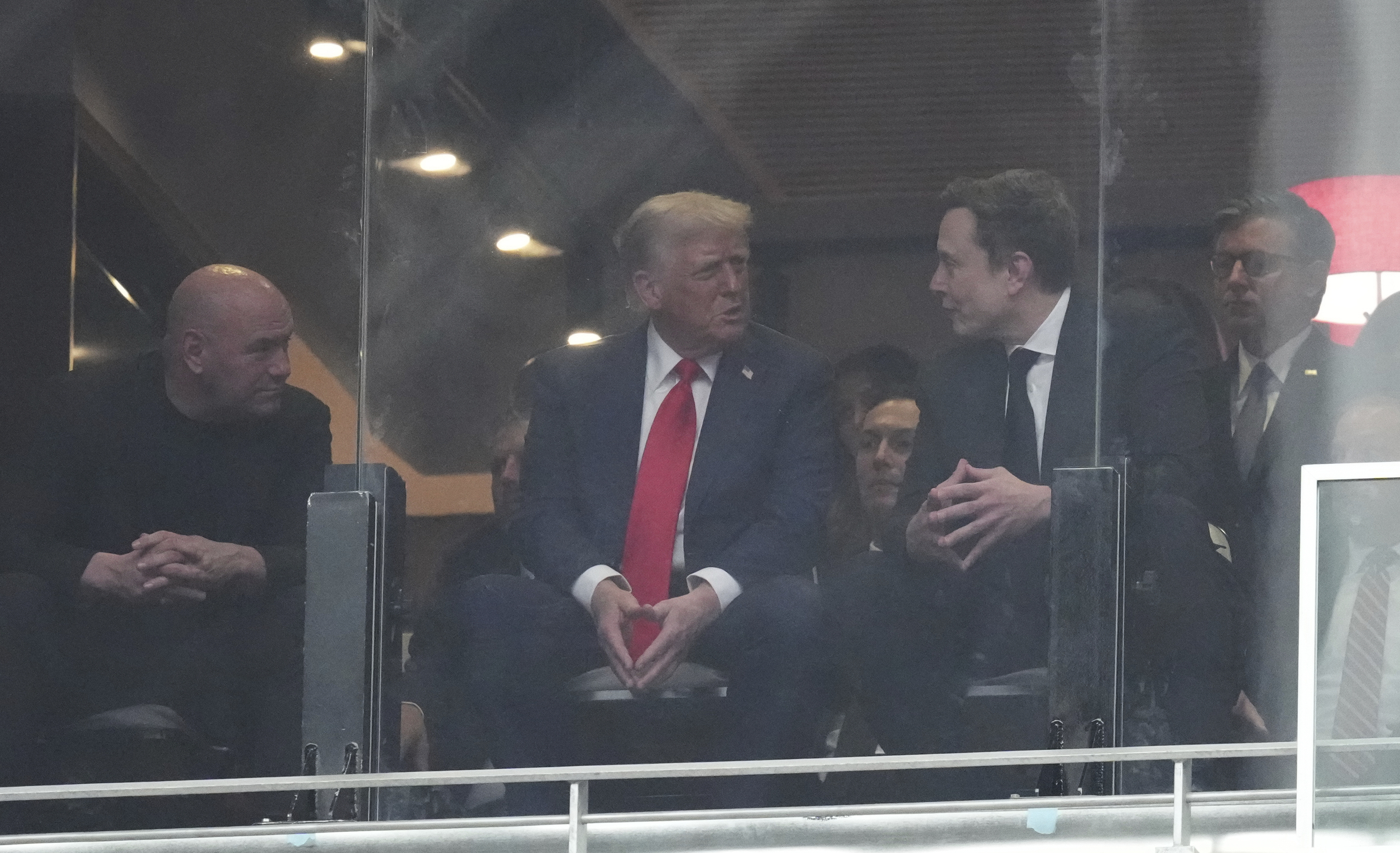 President Donald Trump and Elon Musk talk at the memorial for Charlie Kirk