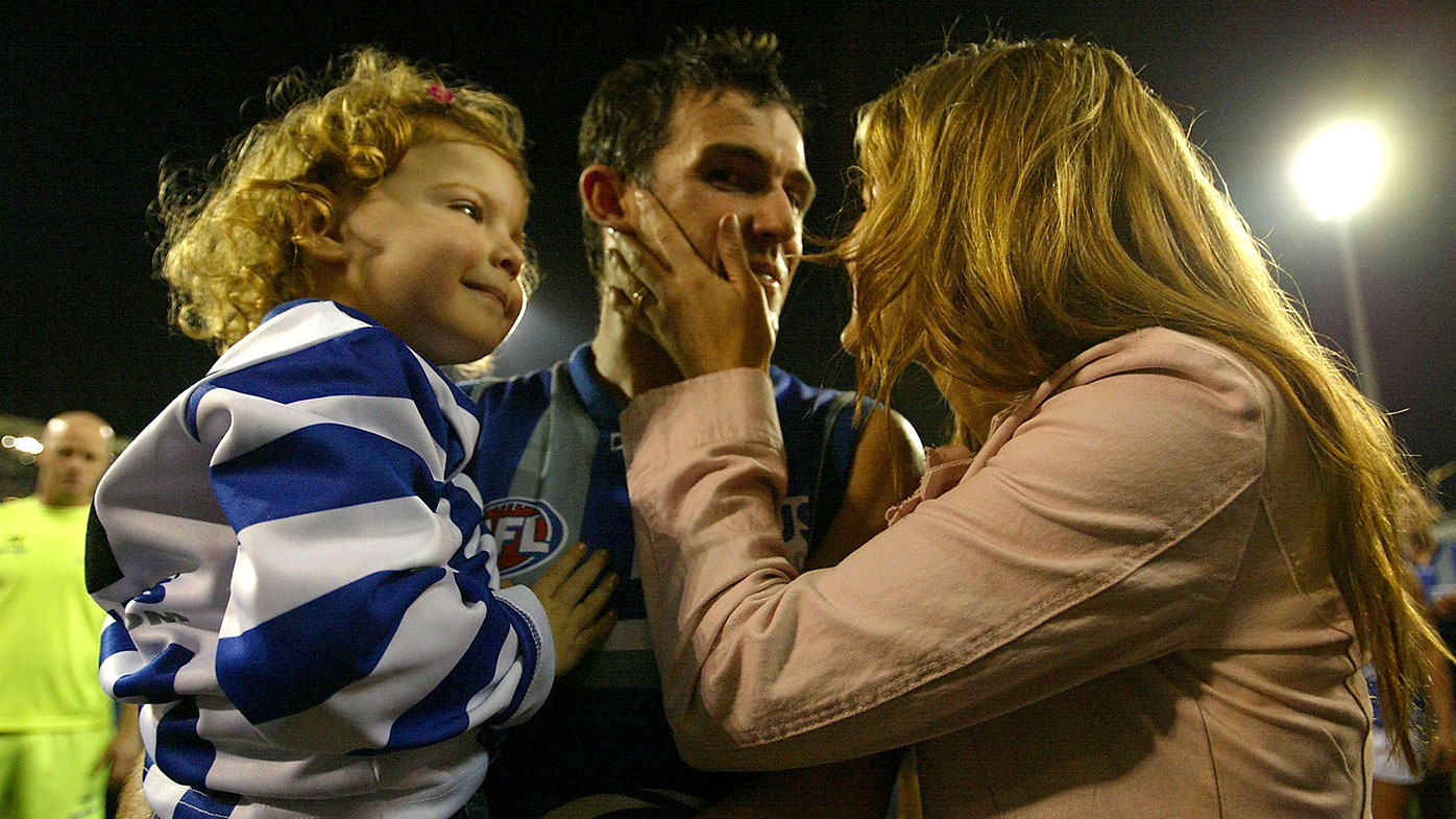  Anthony Stevens is greeted by his wife Kelli and daugher Ayva during the AFL match between the Brisbane Lions and the Kangaroos August 28, 2004 in at the Gabba Brisbane, Australia. (Photo by Jonathan Wood/Getty Images)