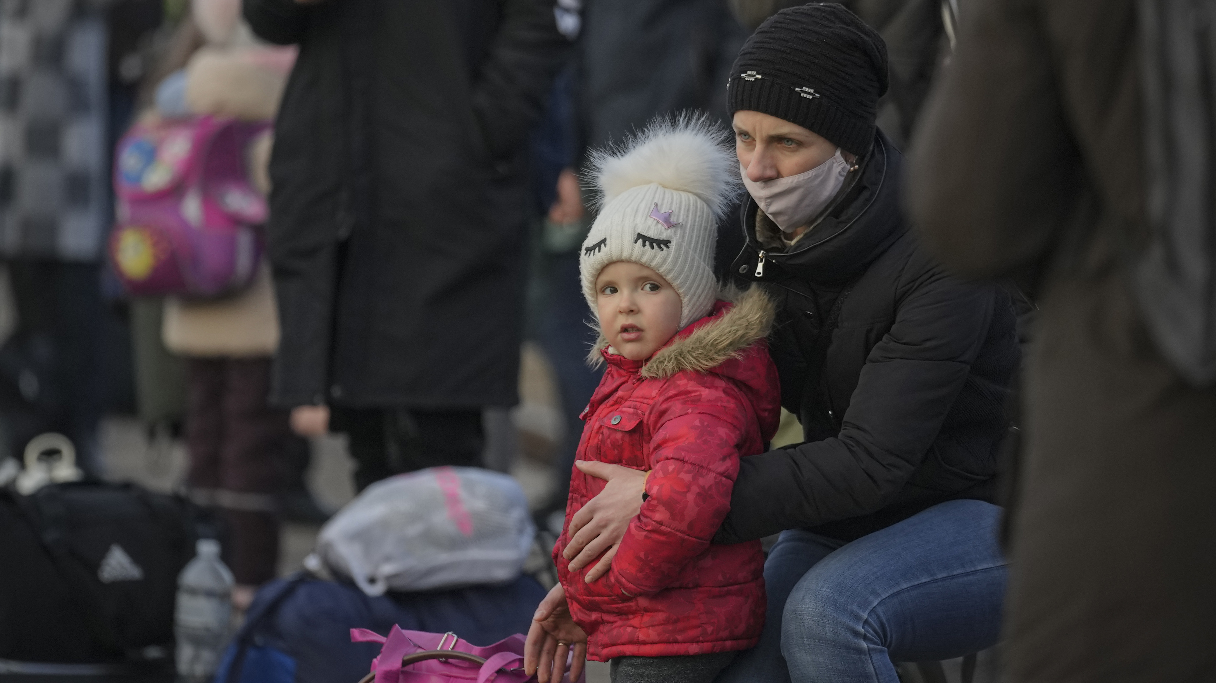 A child with people waiting for a Kyiv bound train gather on the platform in Kramatorsk, the Donetsk region, eastern Ukraine.