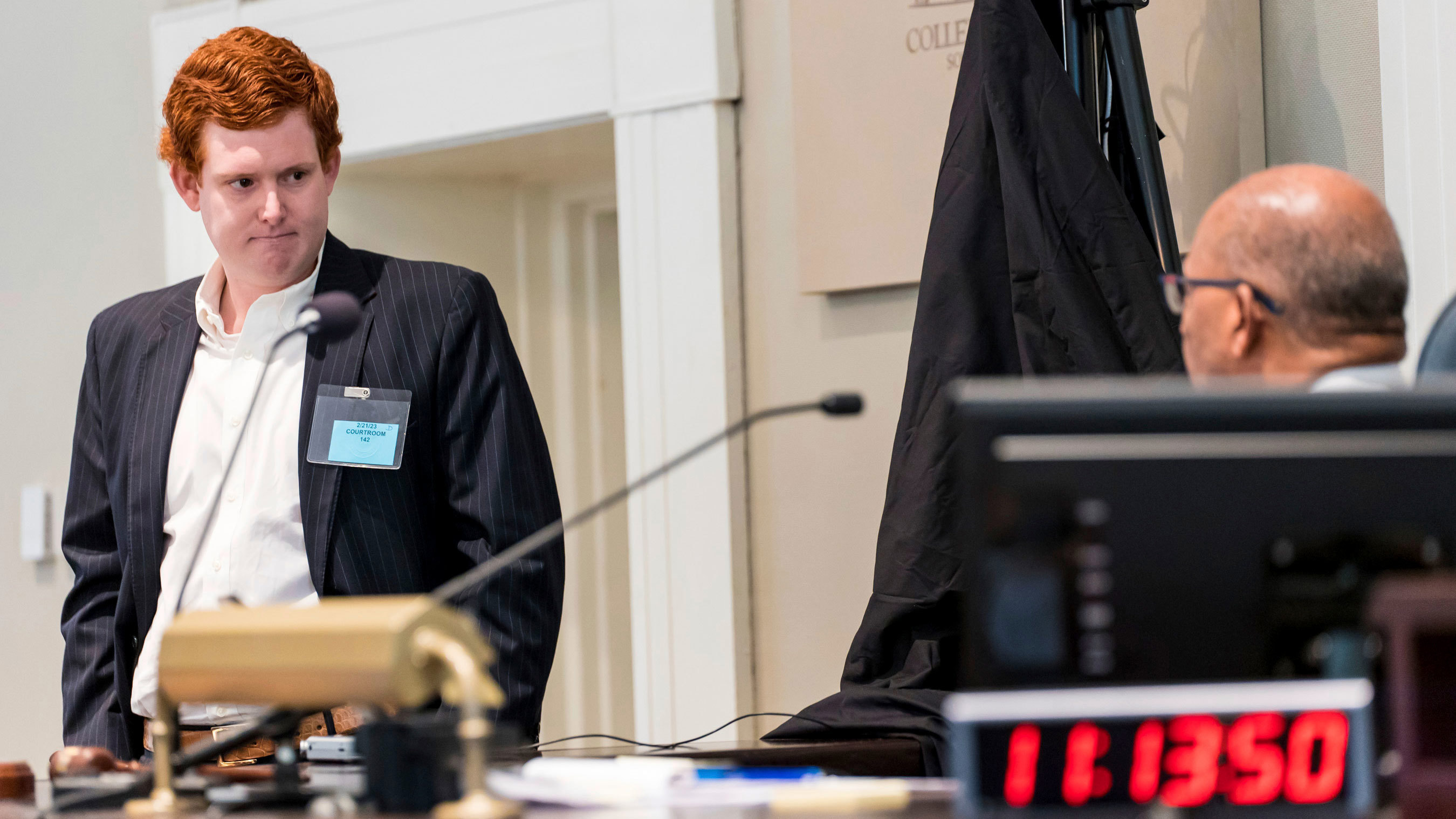 Buster Murdaugh, left, the son of Alex Murdaugh, listens to instruction from Judge Clifton Newman before a break during his father's trial at the Colleton County Courthouse in Walterboro, S.C., on Tuesday, Feb. 21, 2023.