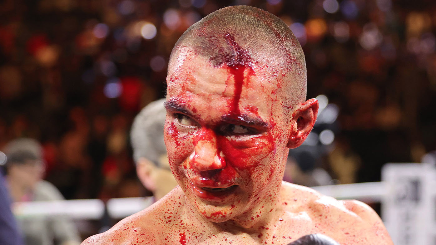 A blood-stained Tim Tszyu.