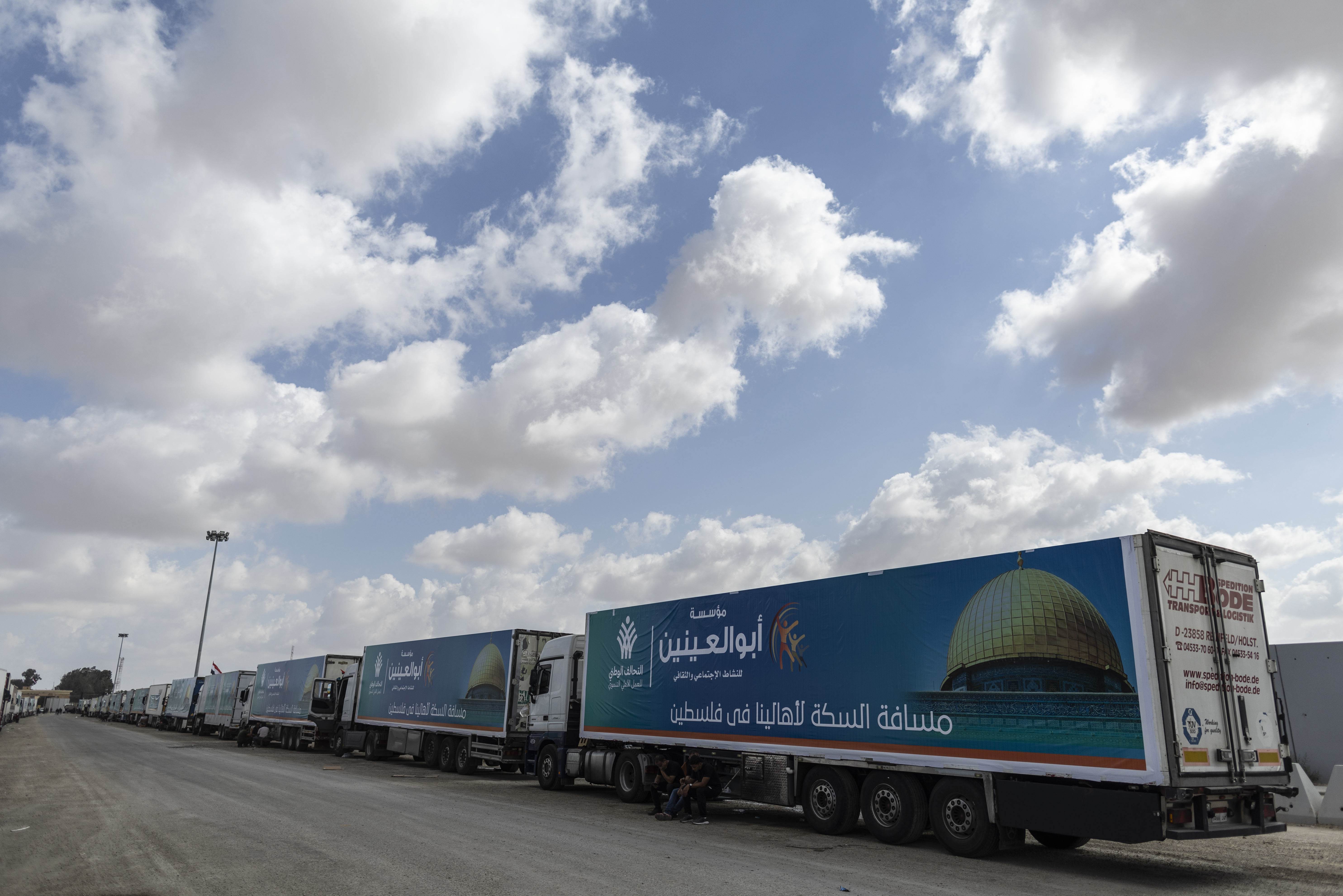 Aid convoy trucks wait at the Rafah border crossing for clearance to enter Gaza on October 19, 2023 in North Sinai, Egypt. 