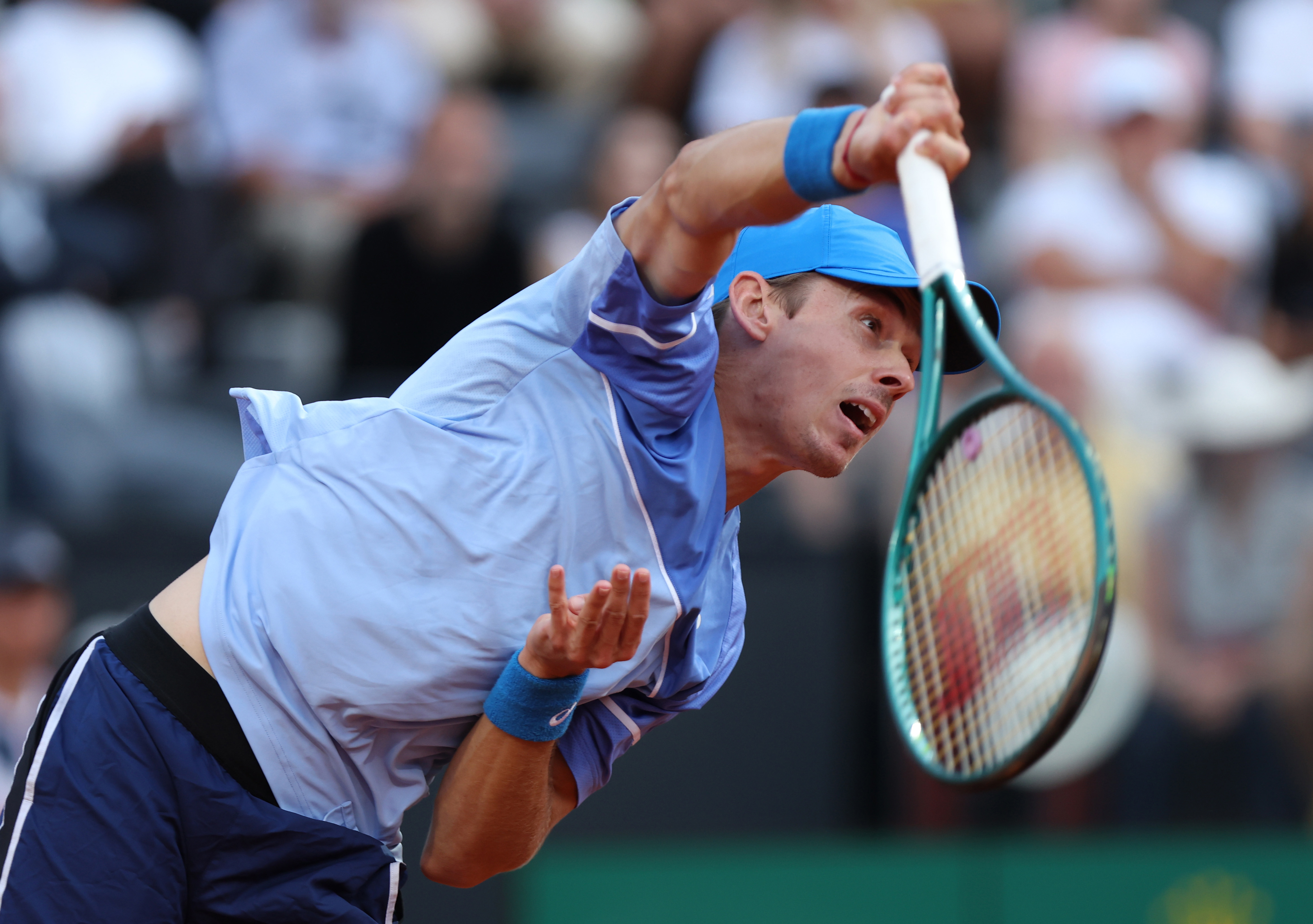 Alex de Minaur of Australia serves against Stefanos Tsitsipas of Greece in Rome.