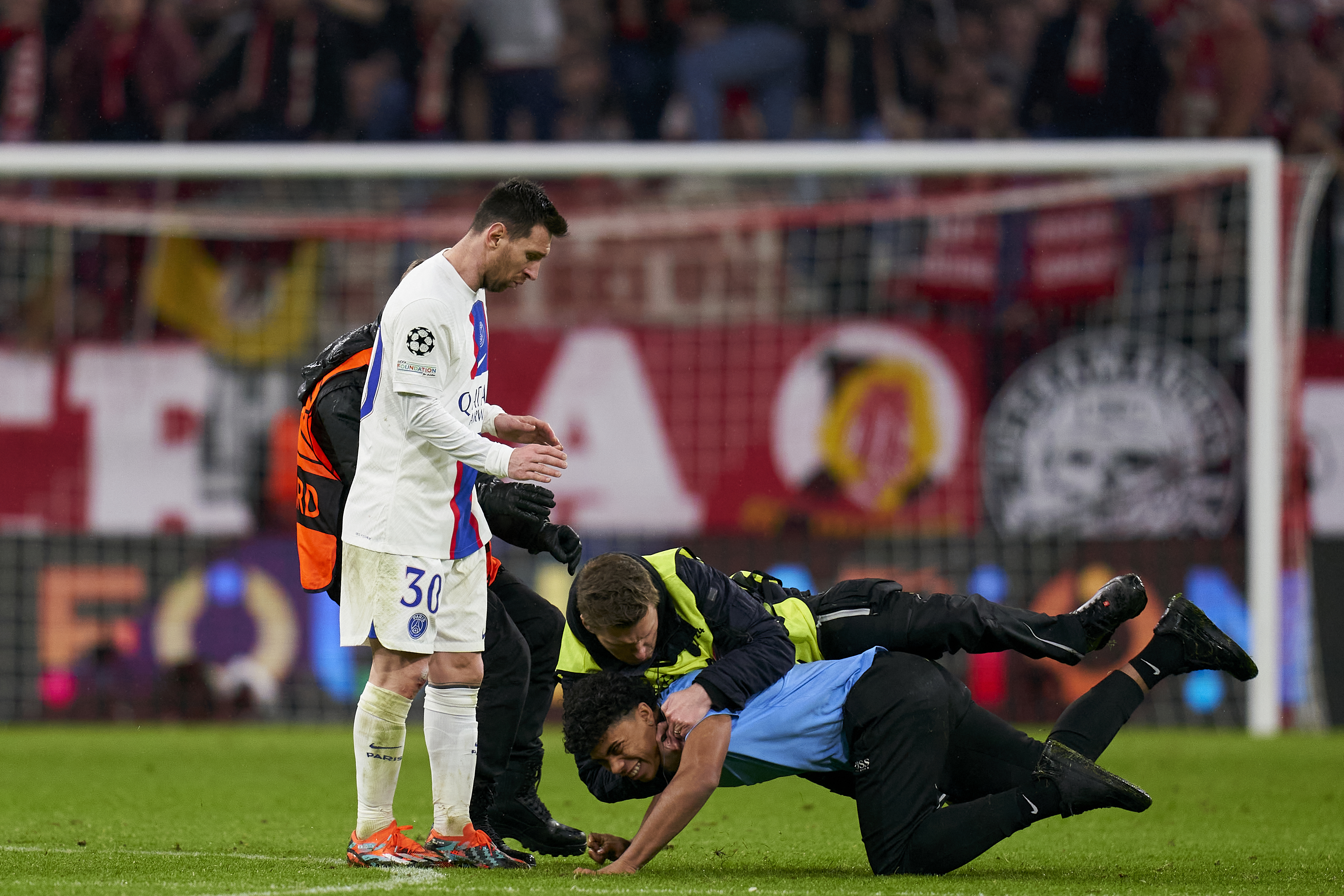 A fan invades the pitch at Allianz Arena.