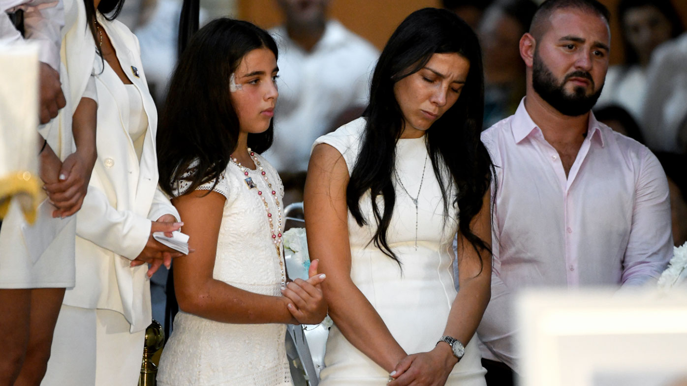 Leila Geagea Abdallah (middle) and daughter (left) are seen during the funeral for her children Antony Abdallah, 13, Angelina Abdallah, 12, and Sienna Abdallah, 8, at Our Lady of Lebanon Co-Cathedral in Sydney