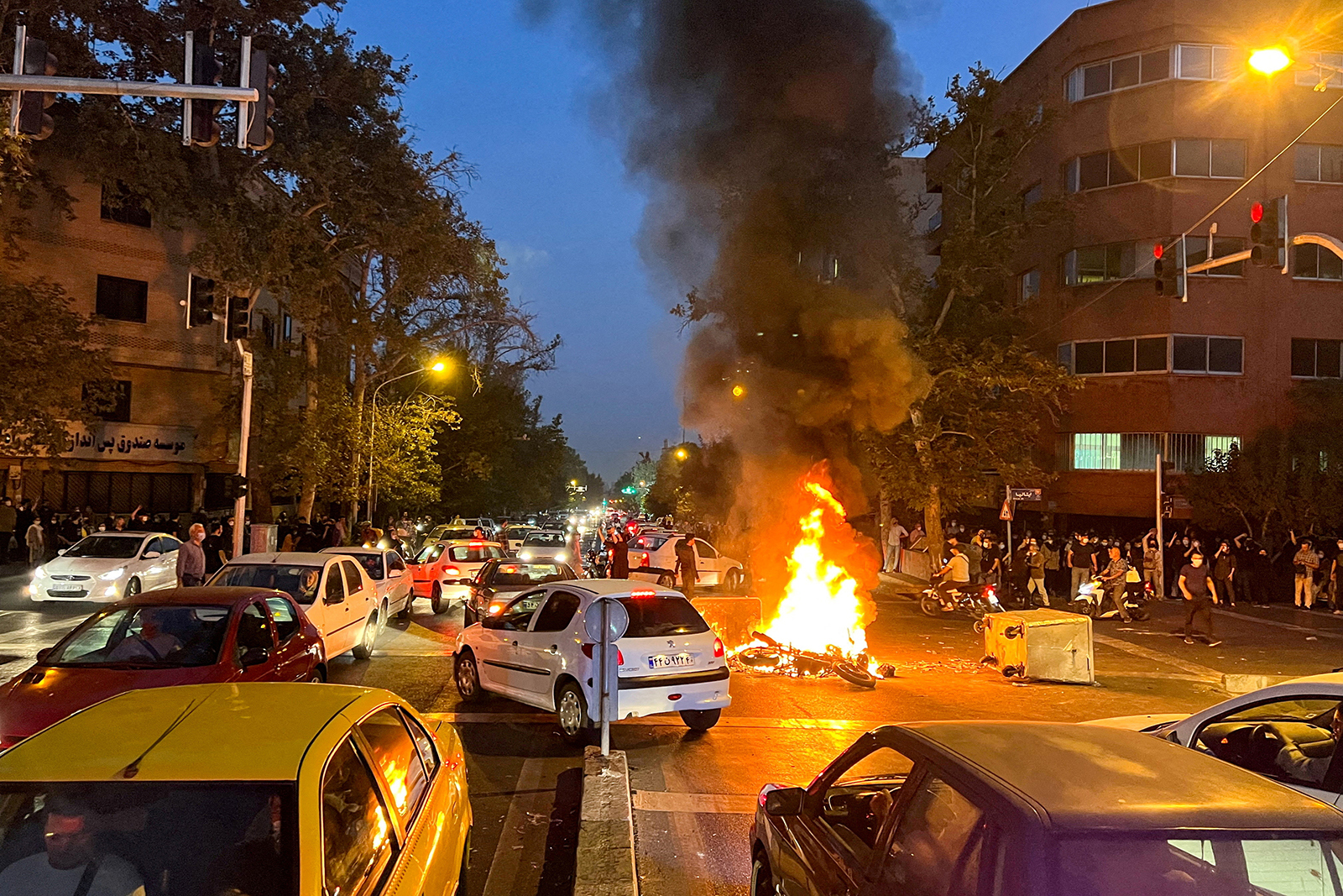 A police motorcycle burns during a protest over the death of Mahsa Amini, a woman who died after being arrested by the Islamic republic's "morality police", in Tehran, Iran September 19, 2022.  