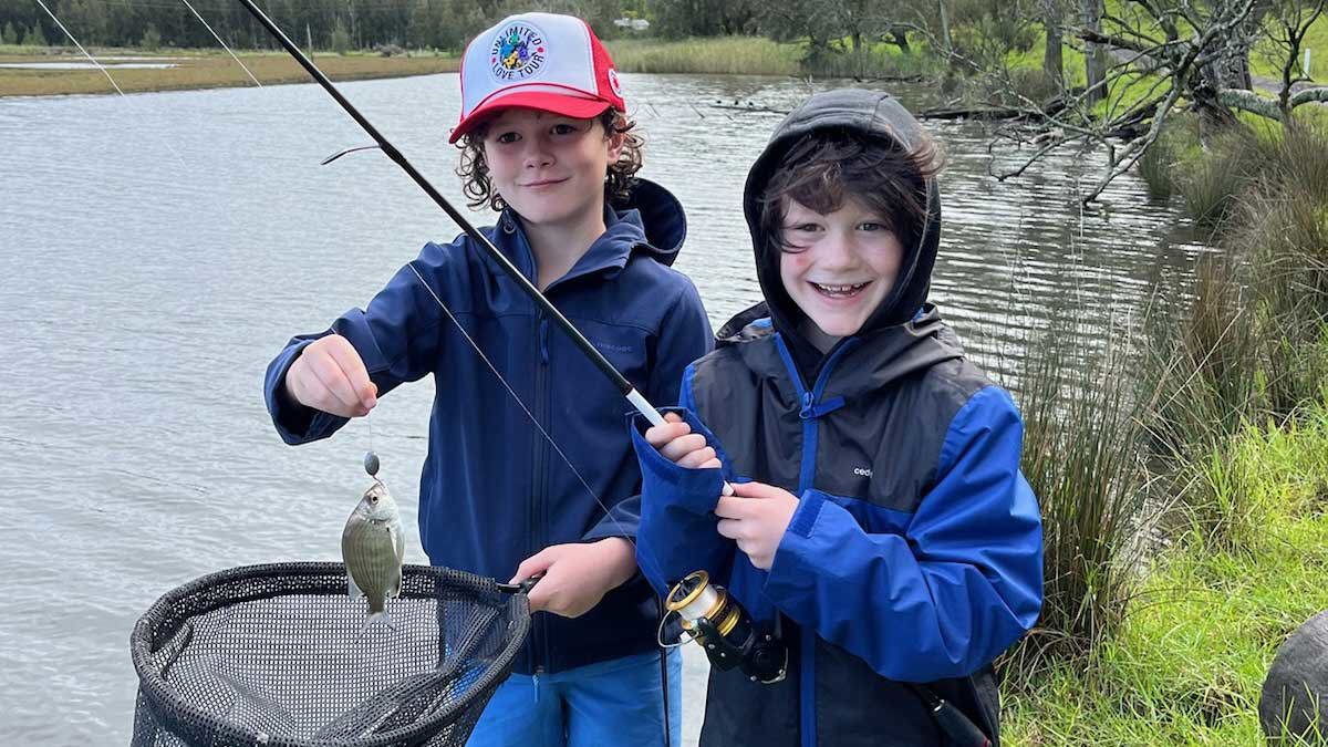 Ben and ﻿his older brother Russell, pictured fishing on the banks of a river.