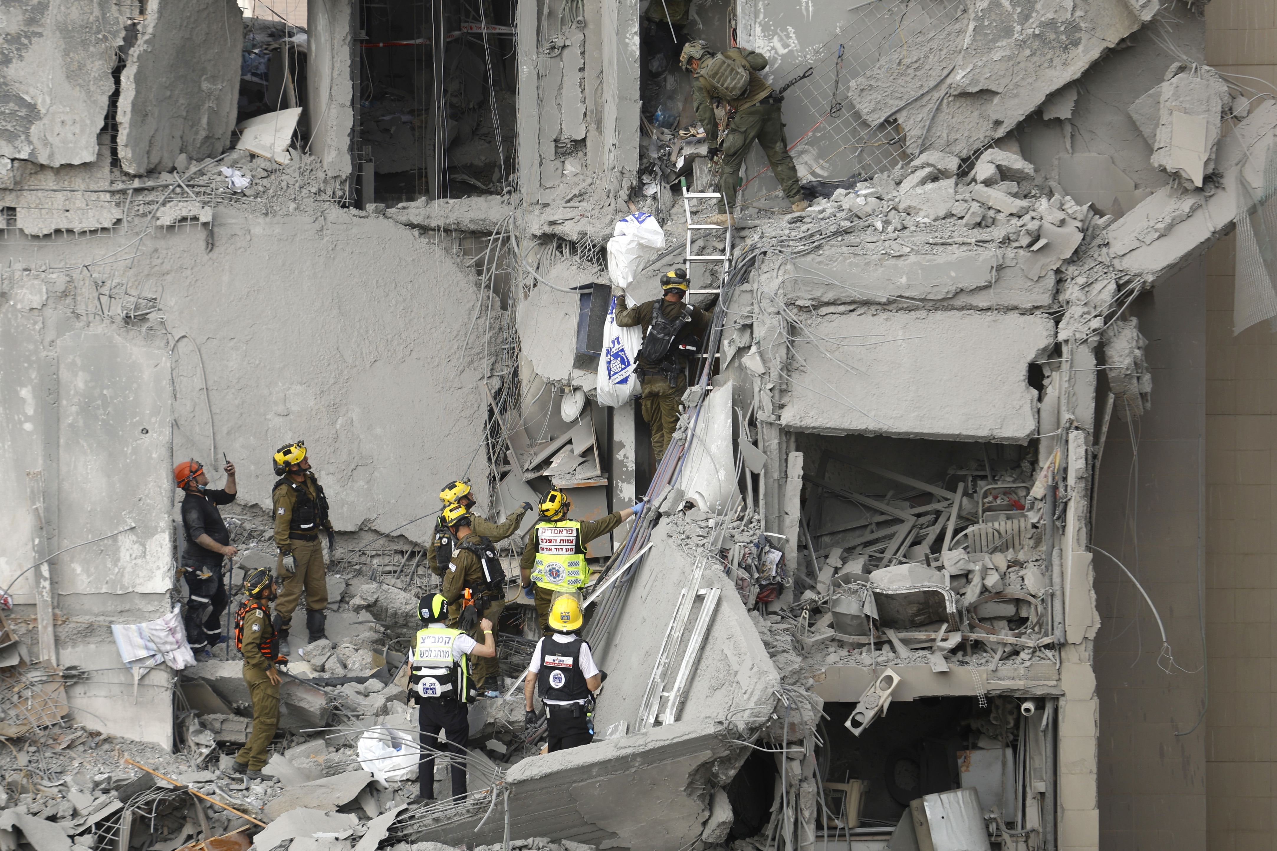 BEERSHEBA, ISRAEL - JUNE 24: Emergency responders work at a building where at least four people died in a missile strike on June 24, 2025 in Beersheba, Israel. According to Israeli authorities, Iran launched a barrage of missiles in the early hours this morning, before the start of a purported U.S.-brokered ceasefire between between the two countries. The Iranian foreign minister said that, if Israel stopped its attacks as of this morning, Iran would also end its strikes. (Photo by Amir Levy/Get