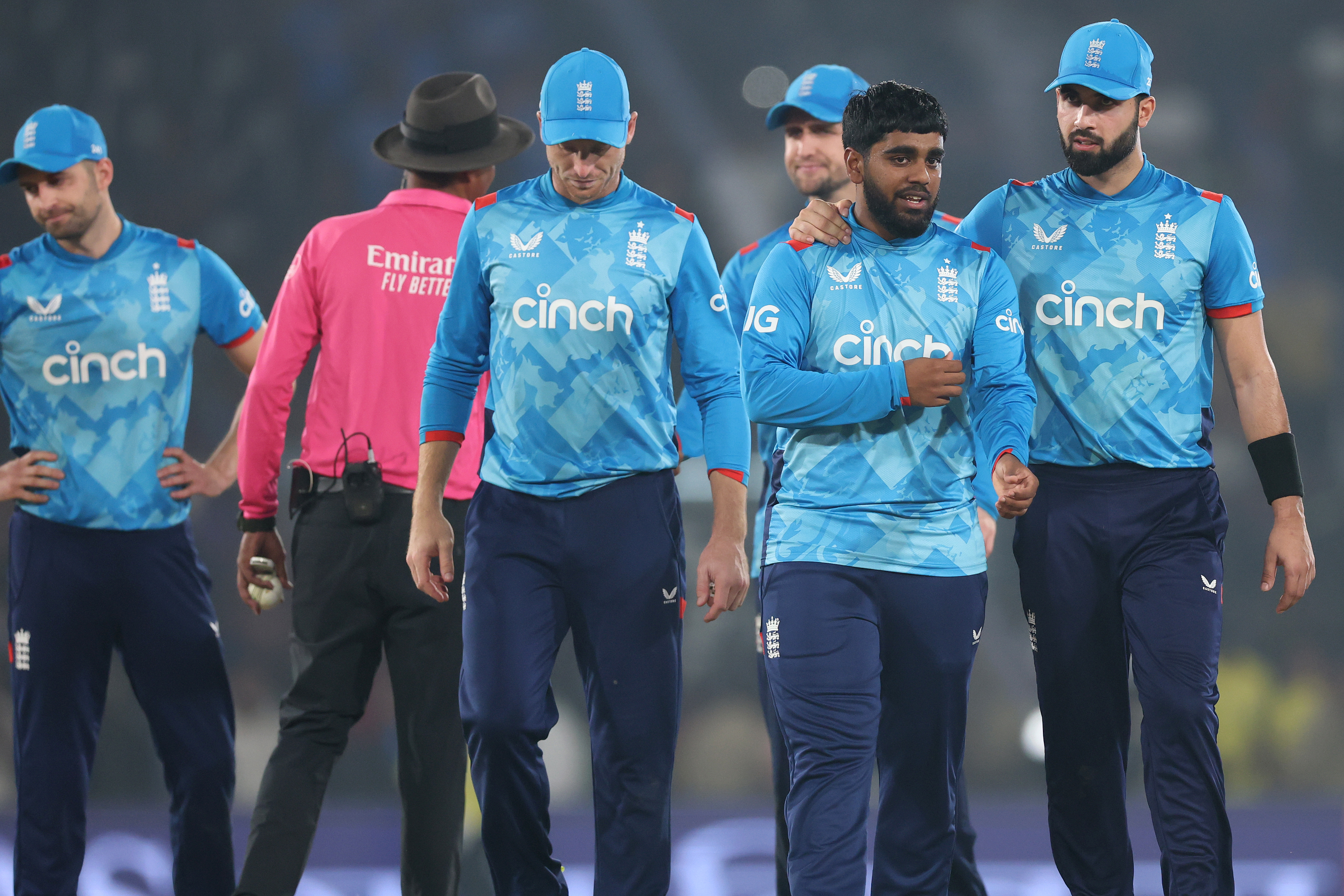 England captain Jos Buttler (C) alongside Rehan Ahmed (2R) and Saqib Mahmood (R) head to the pavilion after the four wicket defeat during the 2nd ODI match between India and England at Barabati Stadium on February 09, 2025 in Cuttack, India. (Photo by Michael Steele/Getty Images)