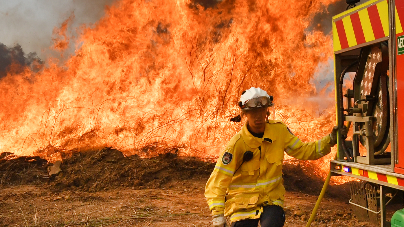 New South Wales Rural Fire Service firefighters are seen back burning and fighting fires on Long Gully Road in the northern New South Wales town of Drake, Monday, September 9, 2019. A number of homes have been destroyed by bushfires in northern New South Wales and Queensland. (AAP Image/Darren England) NO ARCHIVING