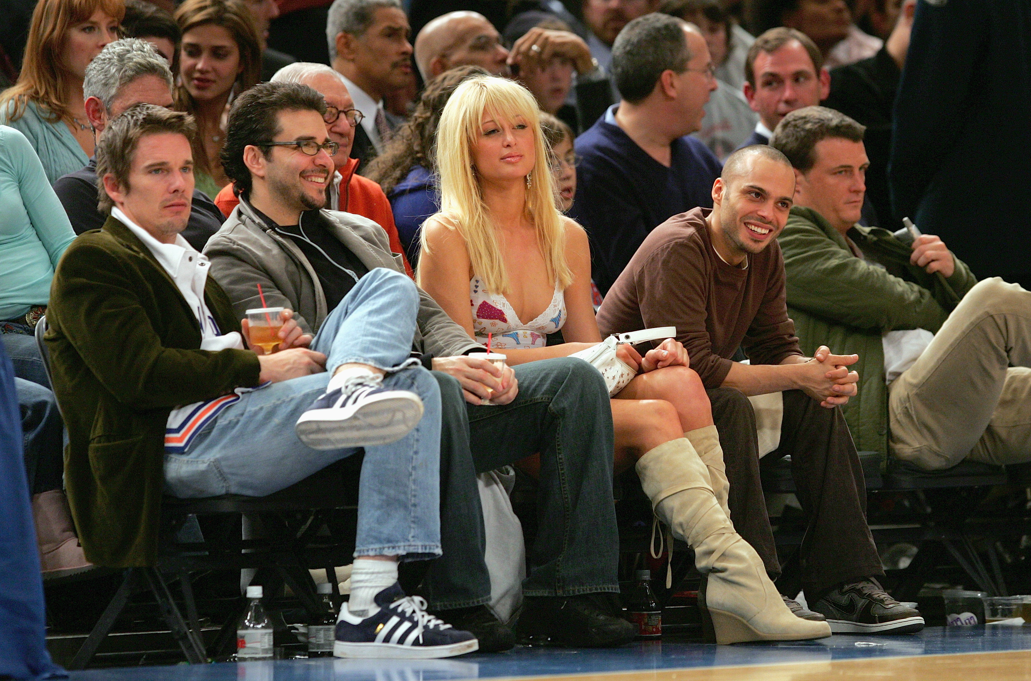 NEW YORK - NOVEMBER 23:  Paris Hilton and Ethan Hawke (L)  watch game action between the Atlanta Hawks and the New York Knicks on November 23, 2004 at Madison Square Garden in New York City, New York. The Knicks defeated the Hawks 104-88.  NOTE TO USER: User expressly acknowledges and agrees that, by downloading and/or using this Photograph, user is consenting to the terms and conditions of the Getty Images License Agreement.  (Photo by Ezra Shaw/Getty Images) *** Local Caption *** Paris Hilton