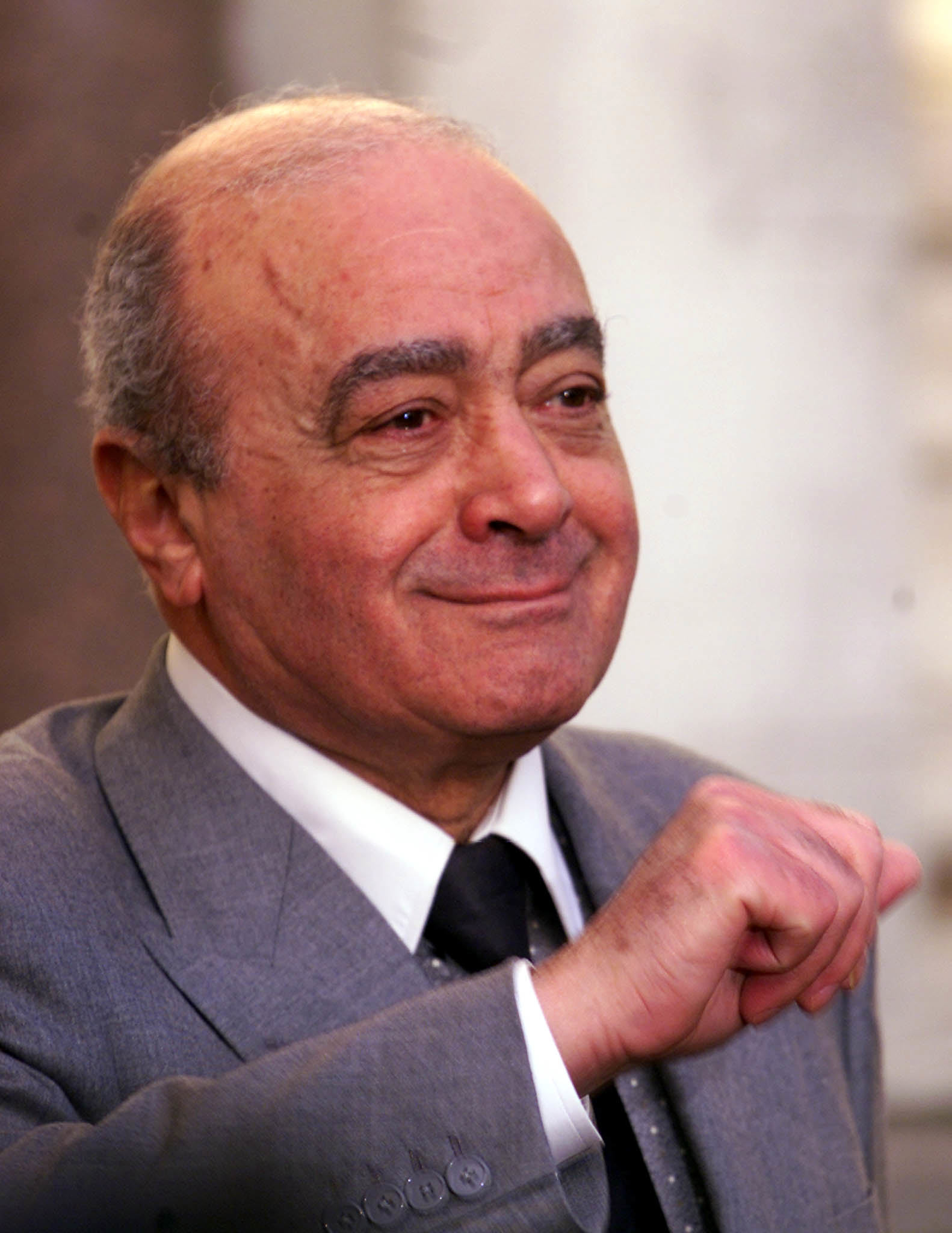 Harrods owner Mohammed Al Fayed smiles as he leaves the High Court in London Monday December 20, 1999 as the jury hearing the libel suit against him retired Monday to consider their verdict. Former Conservative member of parliament Neil Hamilton is taking Al Fayed to court for libel. (AP Photo/Adam Butler)