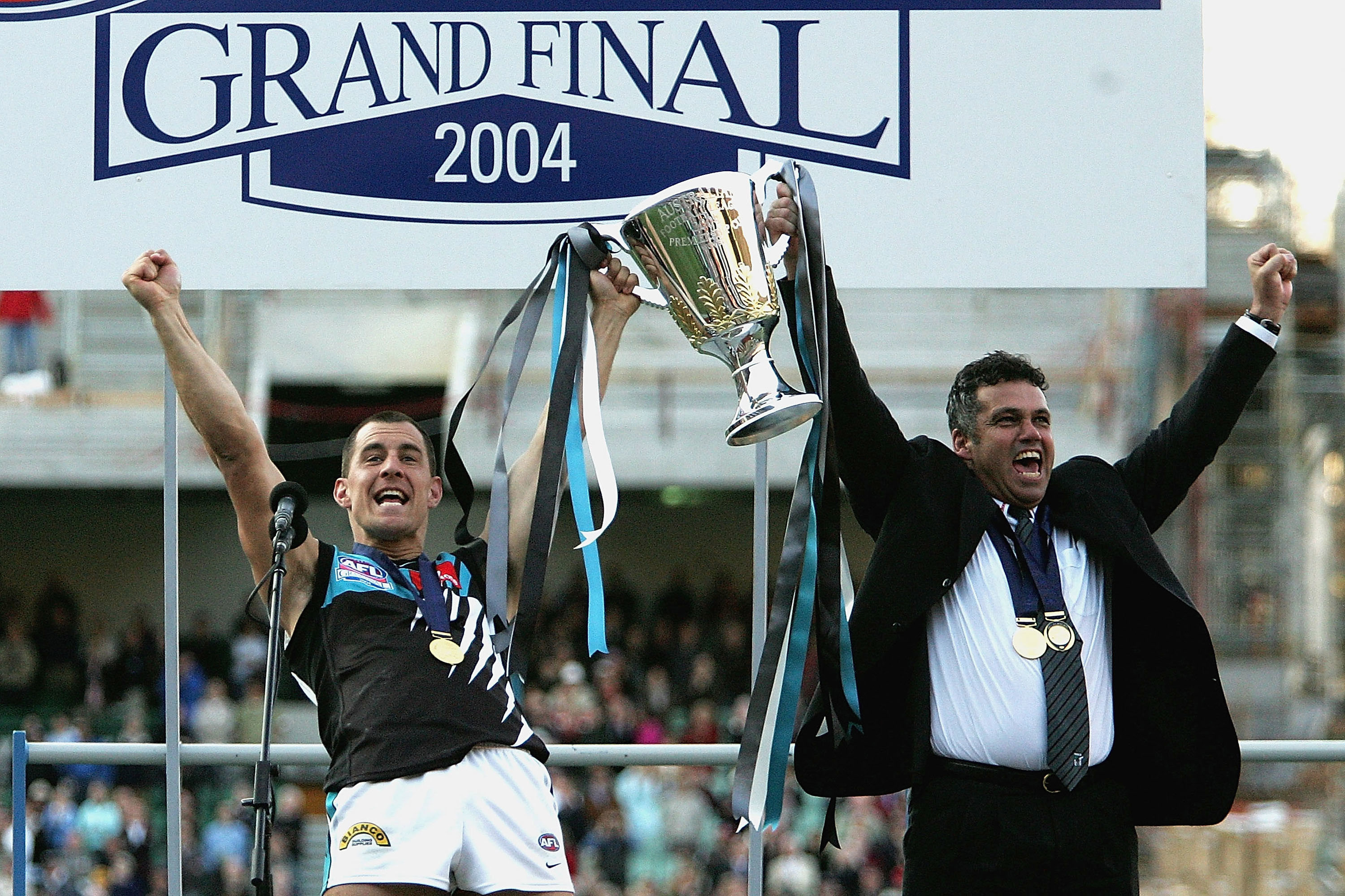 Warren Tredrea and Mark Williams celebrate the Power's one and only AFL premierhsip in 2004.