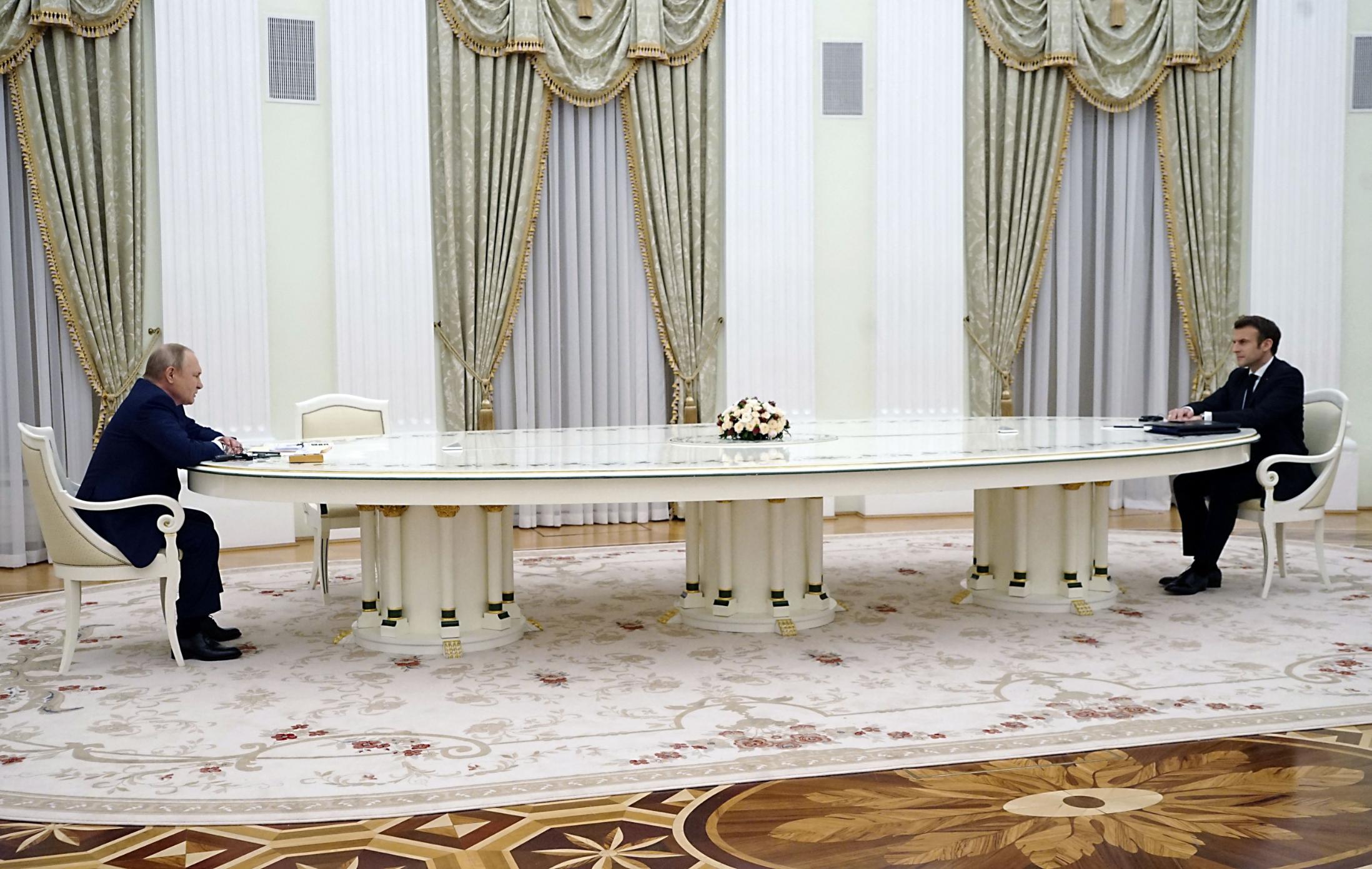 Macron and Putin sat six metres apart at the table.