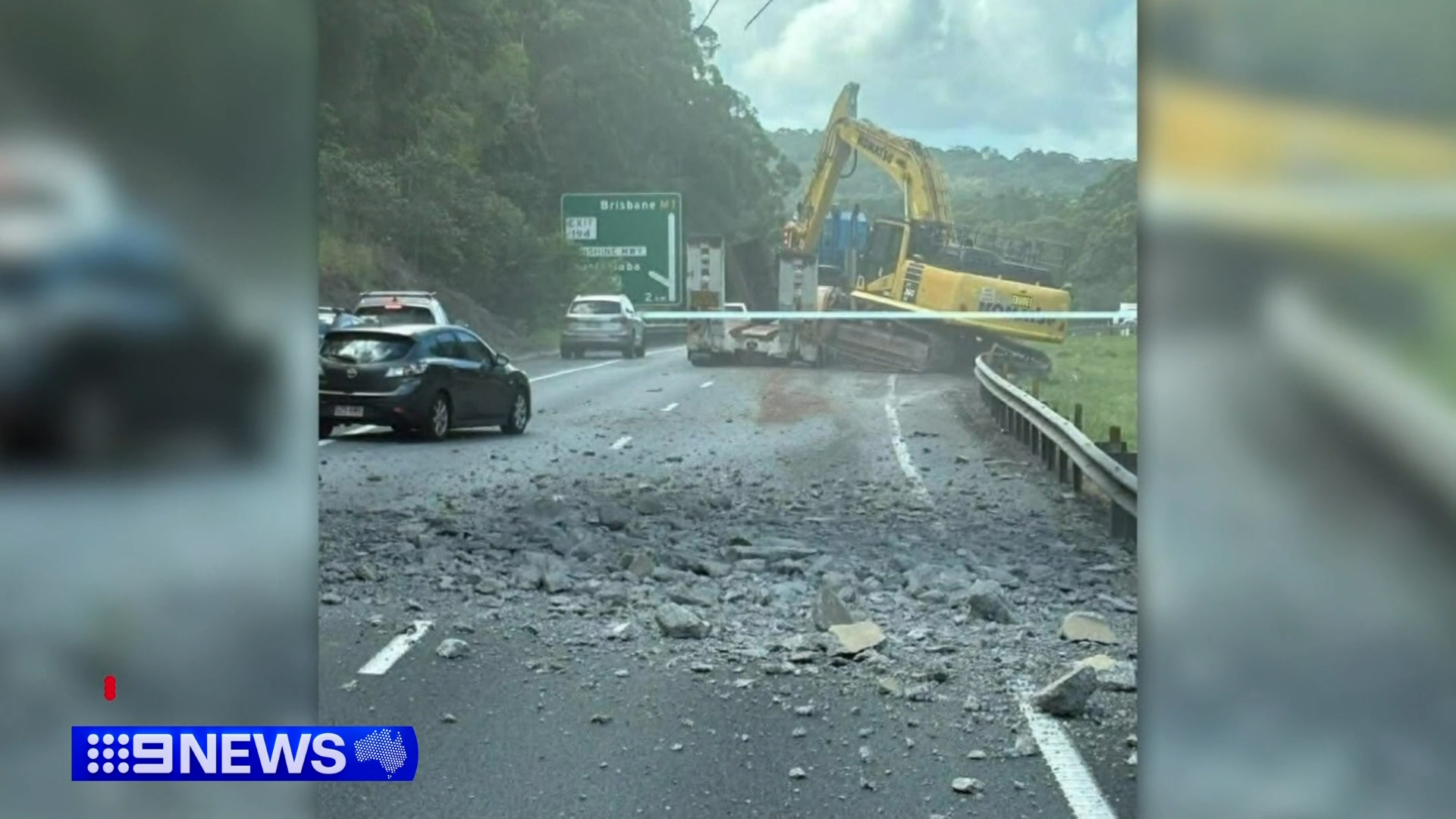 Truck carrying an excavator crashed into an overhead bridge.