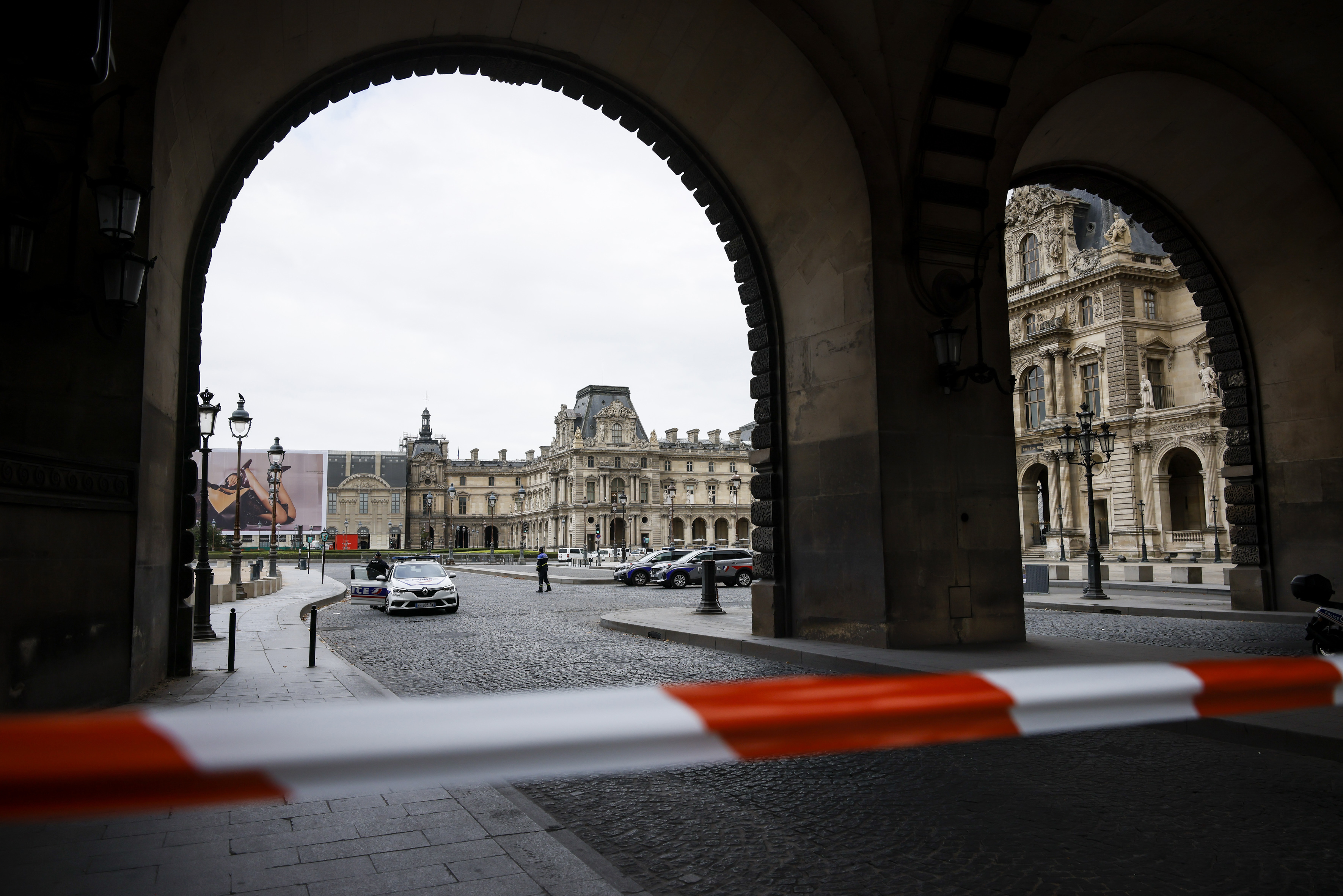 Police officers stand guard outside the Louvre Museum as people are evacuated after it received a written threat, in Paris, Saturday Oct. 14, 2023. 