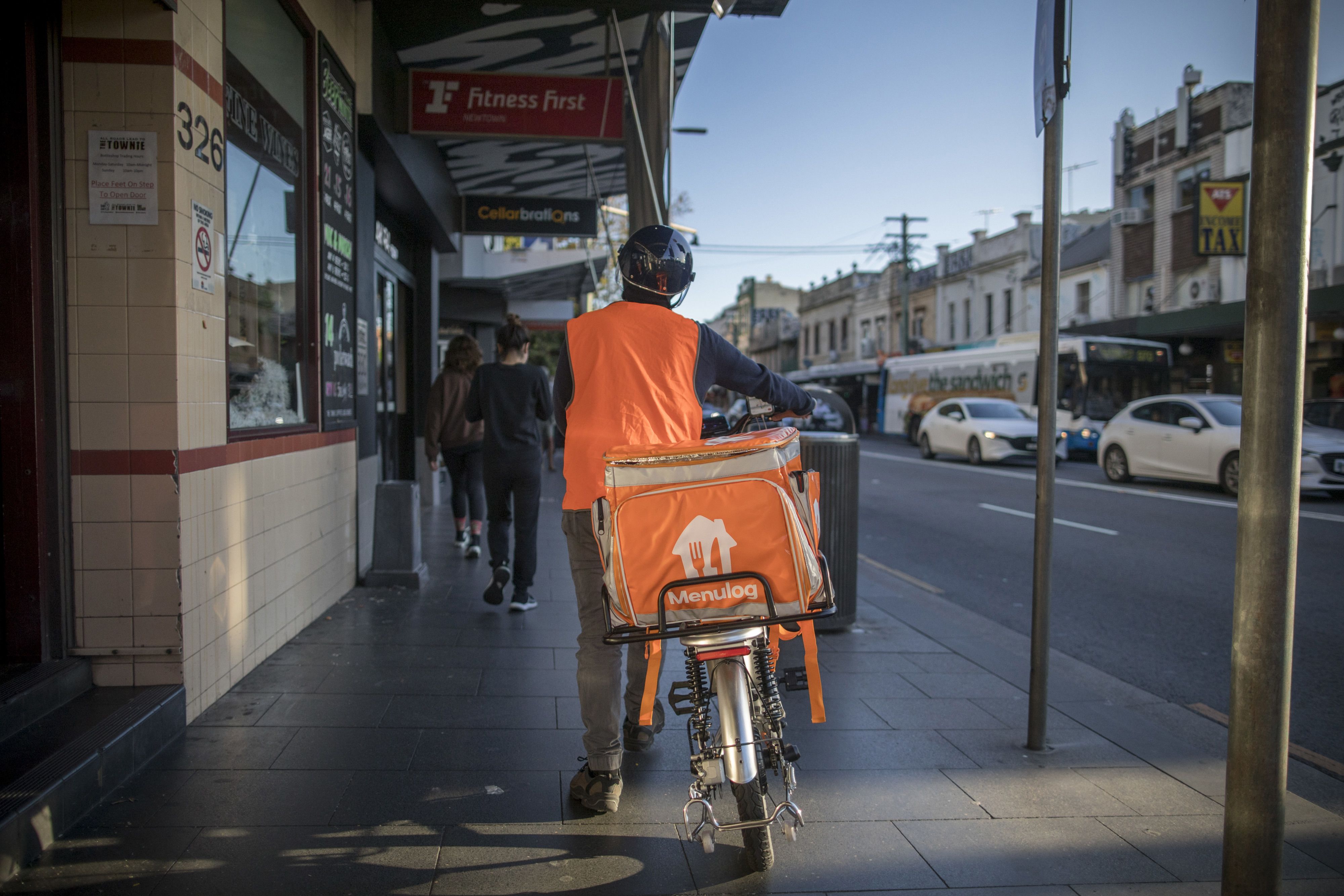 A food delivery courier with a Menulog branded bag in the Newtown area of Sydney, New South Wales, Australia, on Saturday, May 6, 2023.