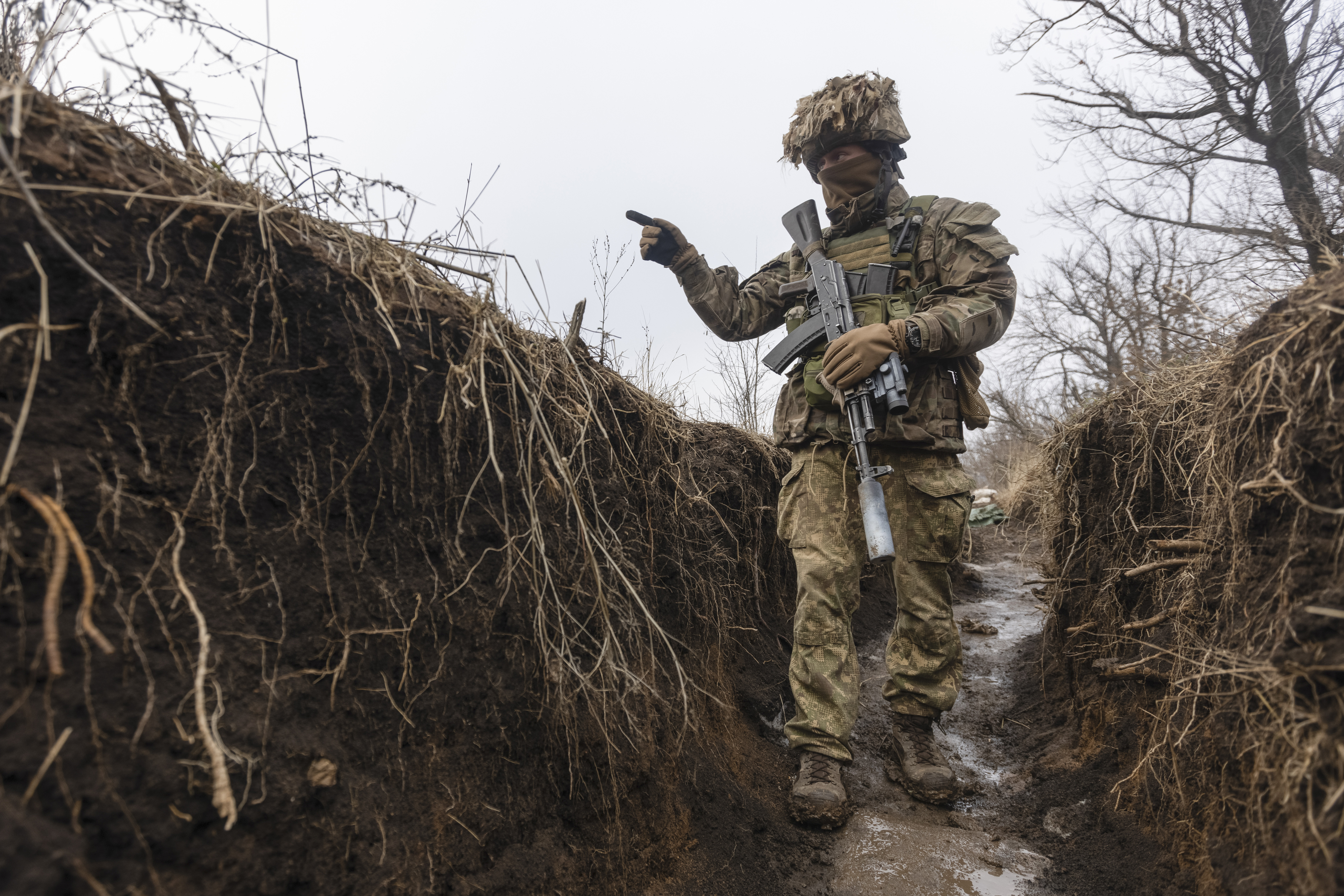 A Ukrainian soldier walks in a trench at the line of separation in Ukraine. 