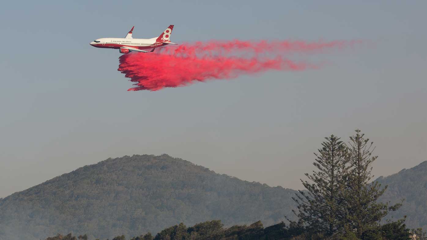 A water bombing plane drops fire retardant on a bushfire at Forster, NSW mid-north coast.