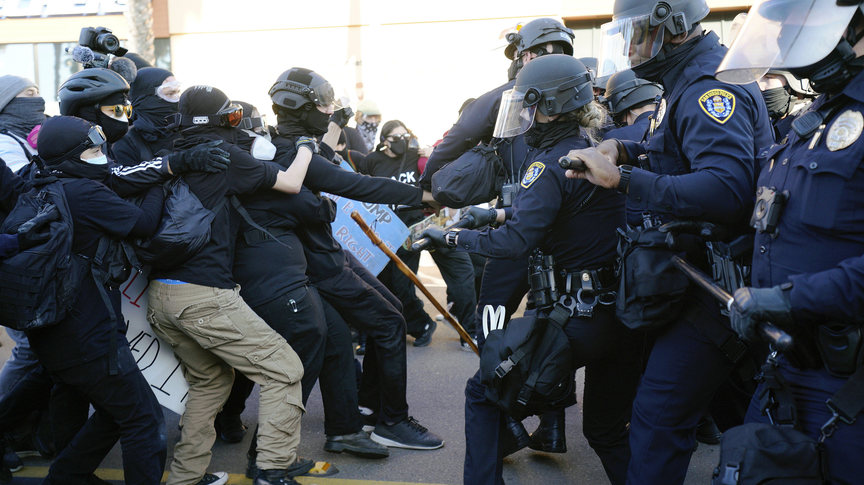San Diego police clash with protesters after a gathering was declared an unlawful assembly.