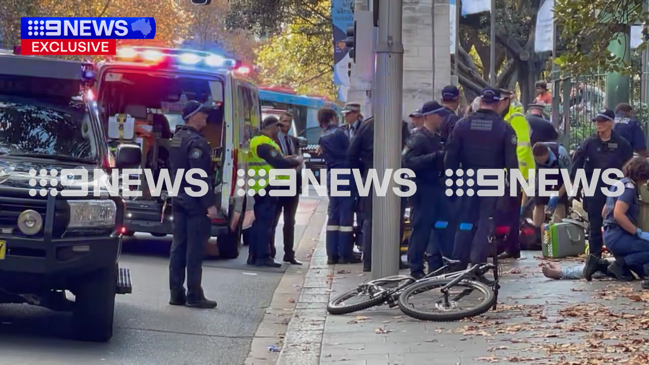 The officer was treated by paramedics at the scene and taken to St Vincent's Hospital.