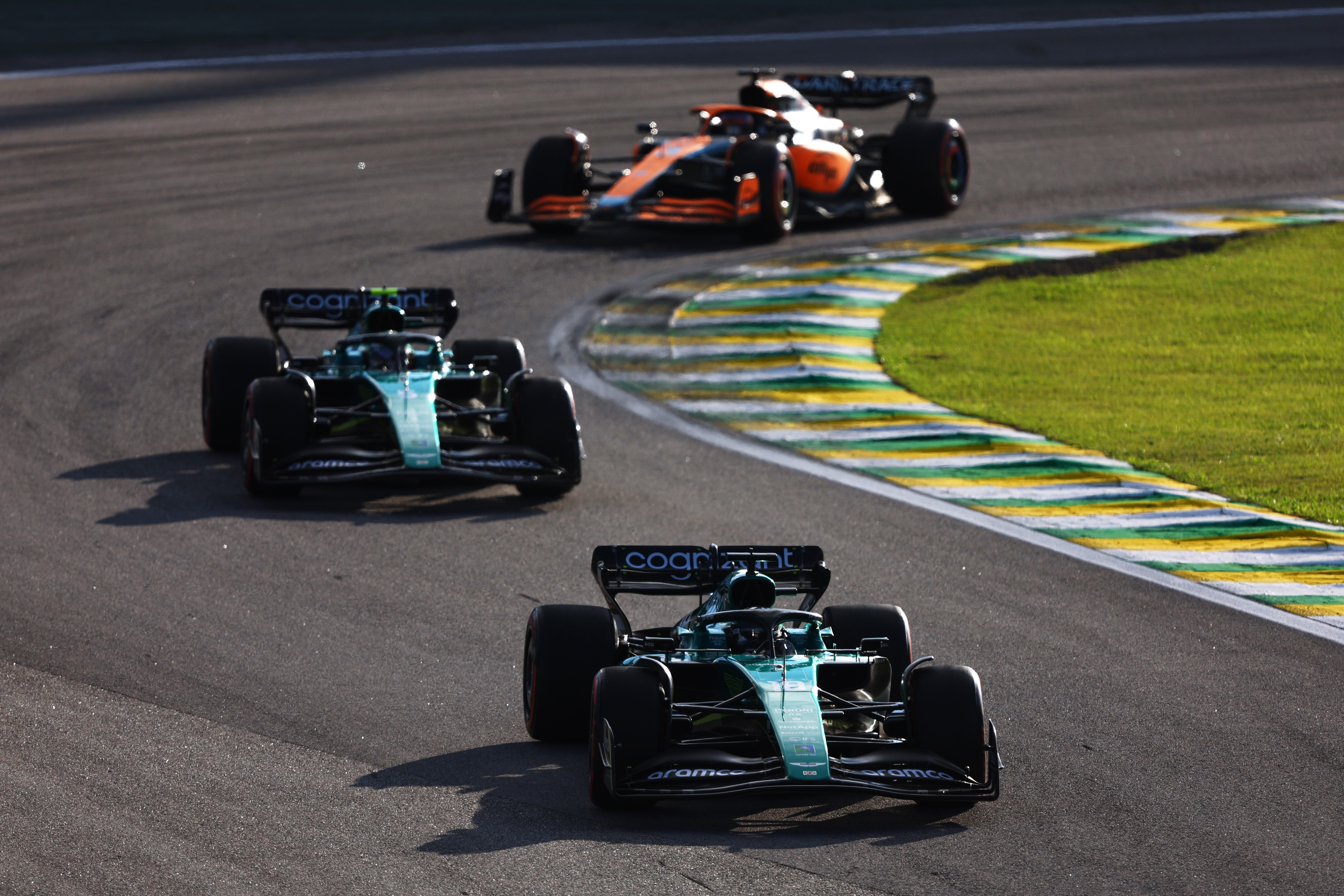 Lance Stroll of Canada driving the (18) Aston Martin AMR22 Mercedes leads Sebastian Vettel of Germany driving the (5) Aston Martin AMR22 Mercedes and Daniel Ricciardo of Australia driving the (3) McLaren MCL36 Mercedes on track during the Sprint ahead of the F1 Grand Prix of Brazil at Autodromo Jose Carlos Pace on November 12, 2022 in Sao Paulo, Brazil. (Photo by Bryn Lennon - Formula 1/Formula 1 via Getty Images)