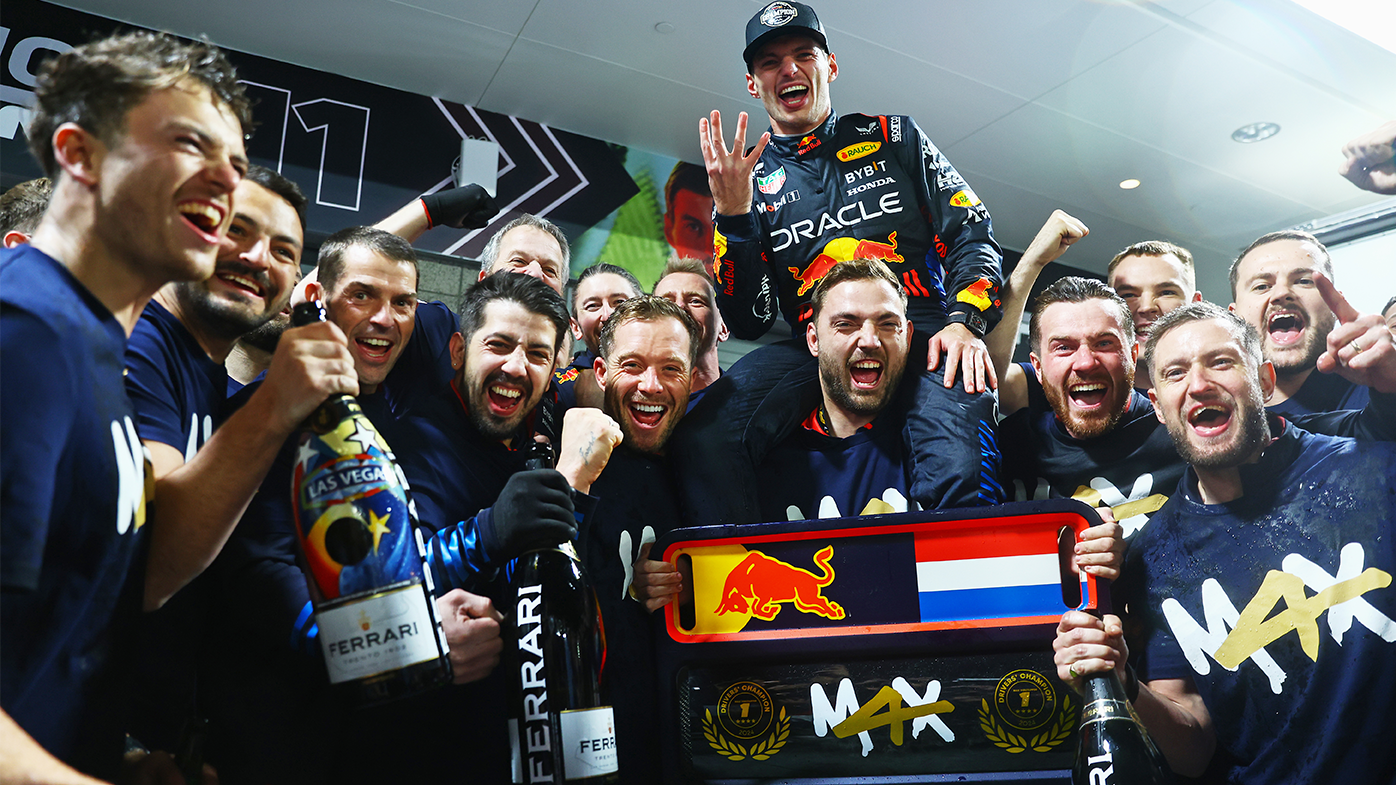 Max Verstappen celebrates with his team after clinching the F1 world drivers championship. 