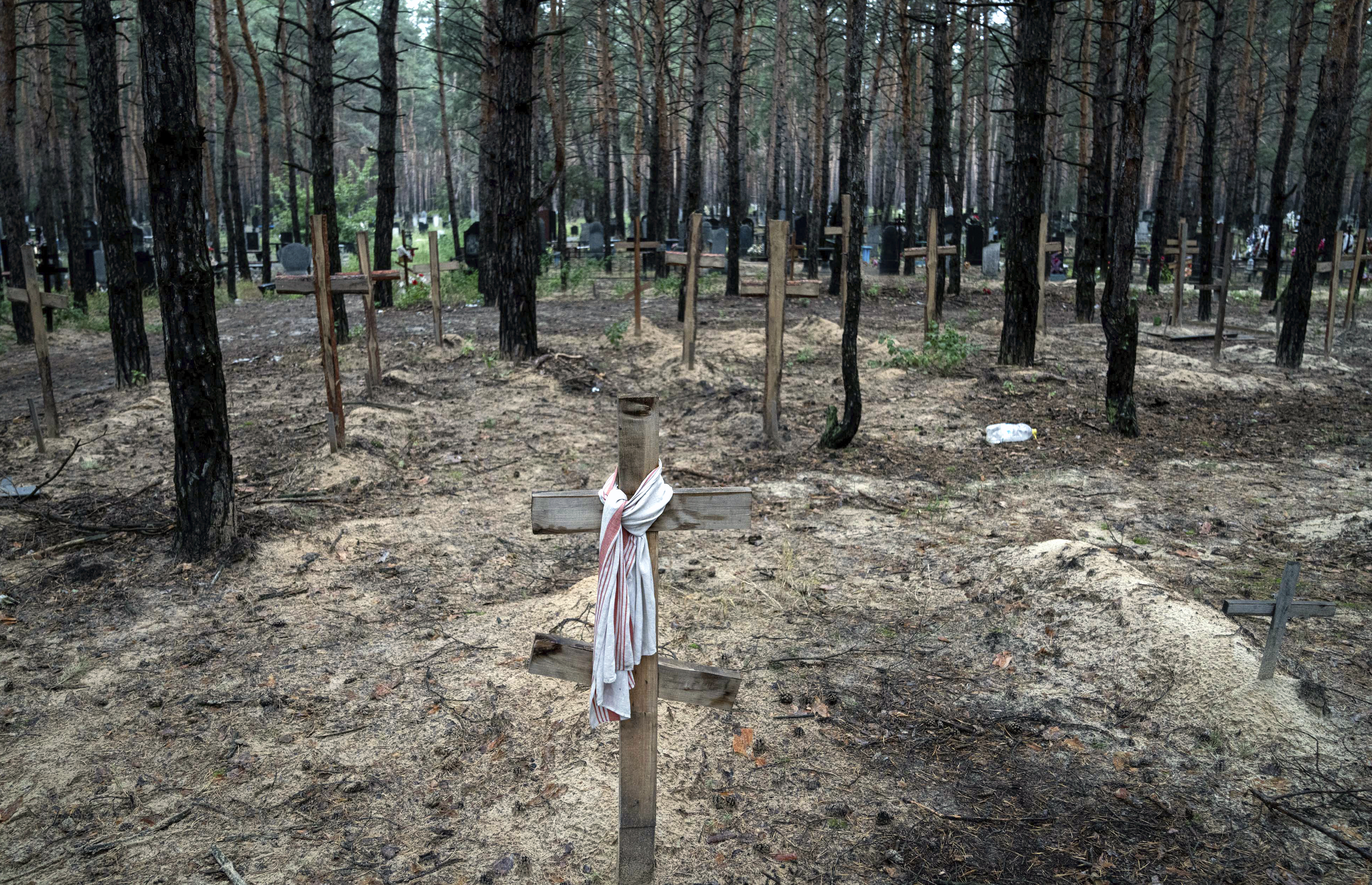A view shows unidentified graves of civilians and Ukrainian soldiers in a cemetery, in the recently retaken area of Izium, Ukraine, Friday, Sept. 16, 2022. 