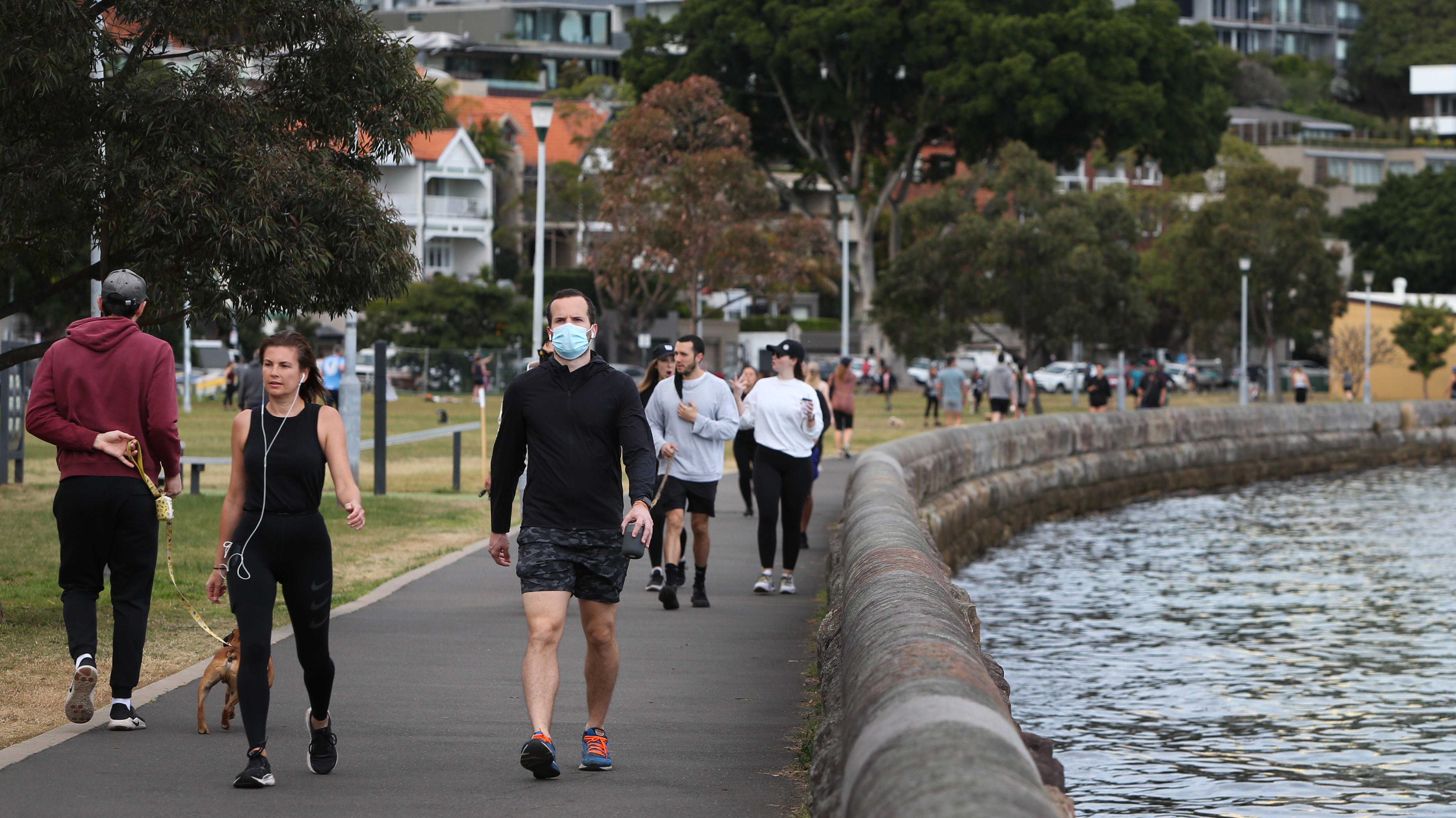 People exercising in the early morning at Rushcutters Bay in Sydney.