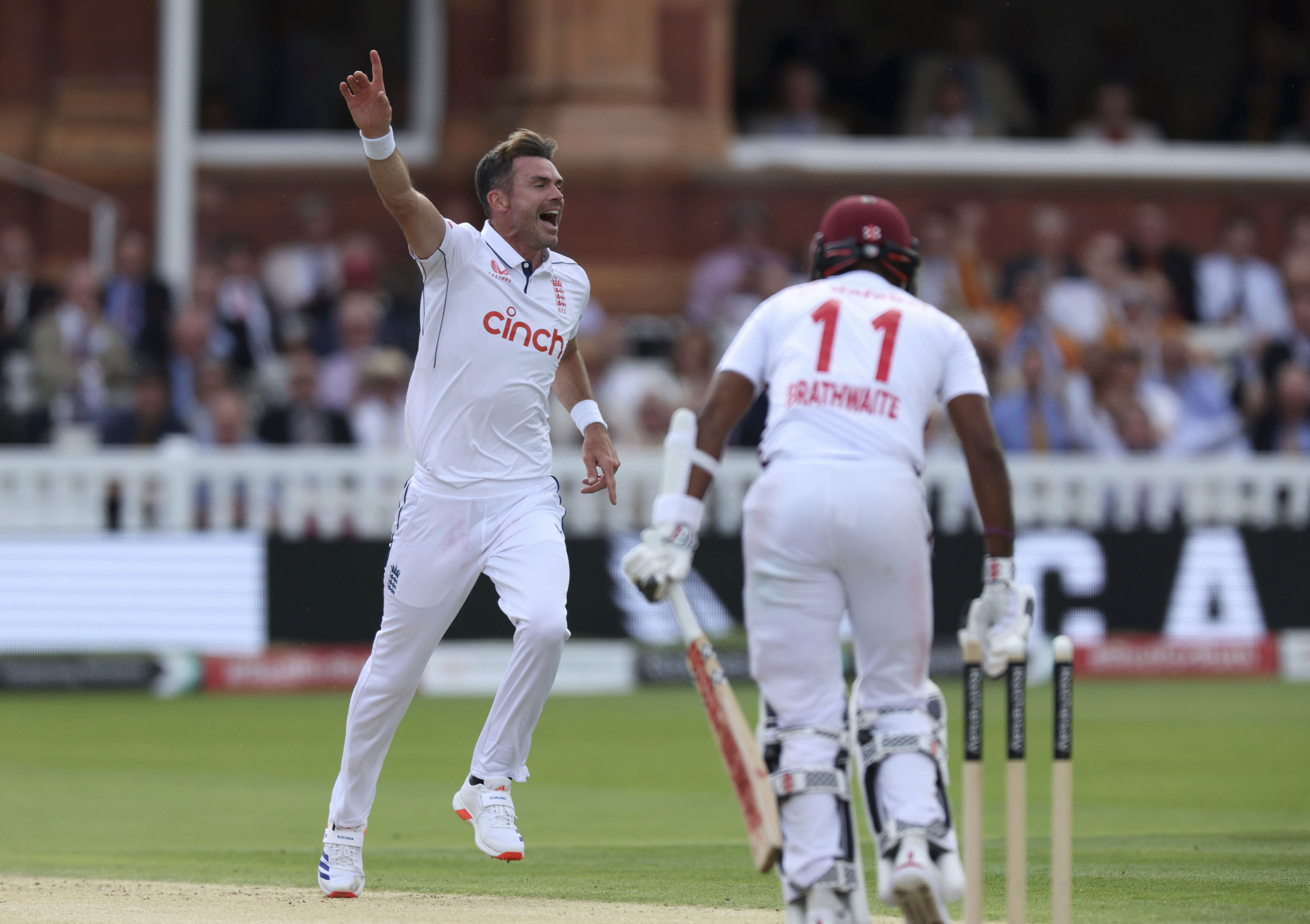 England's James Anderson celebrates bowling out West Indies' Kraigg Brathwaite.