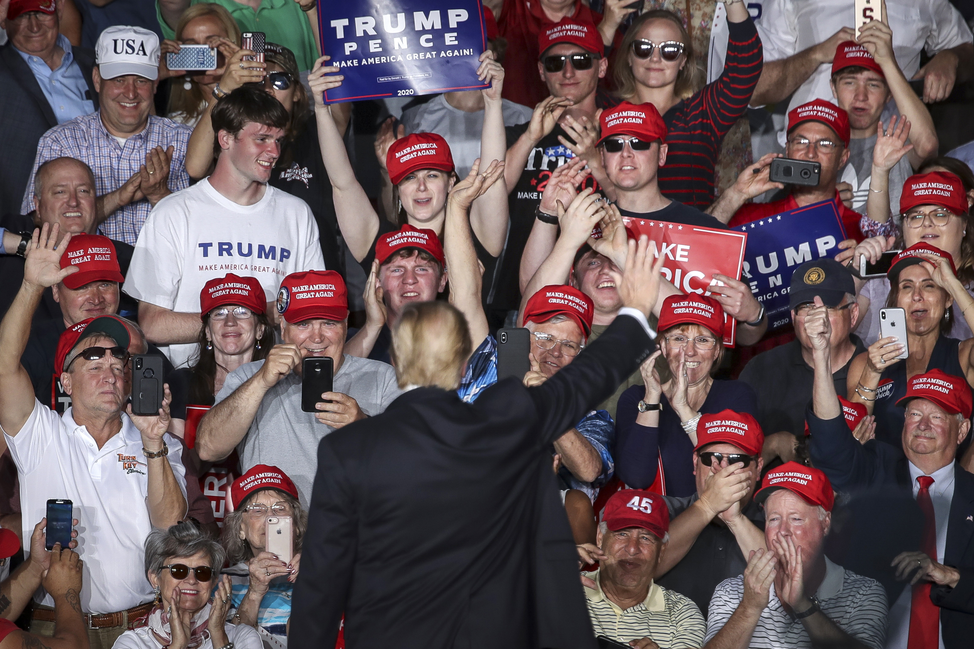 The crowd cheers as U. President Donald Trump waves at the end of a 'Make America Great Again' campaign rally at Williamsport Regional Airport, in Montoursville, Pennsylvania