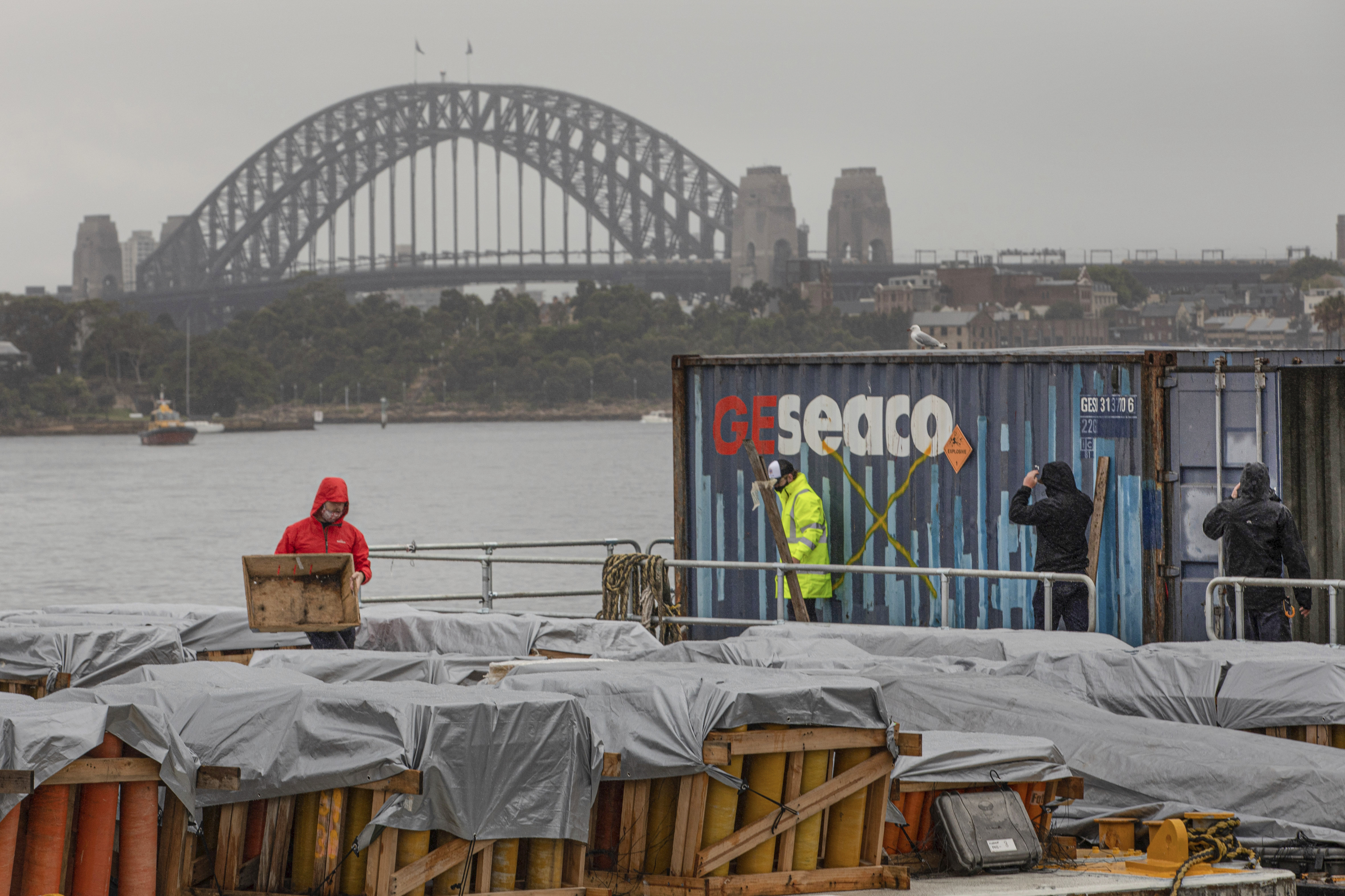 Foti International Fireworks workers ready a barge filled with fireworks for the 2021 NYE fireworks display at Glebe Island in Sydney on Wednesday, December 29, 2021. Photo by Cole Bennetts.