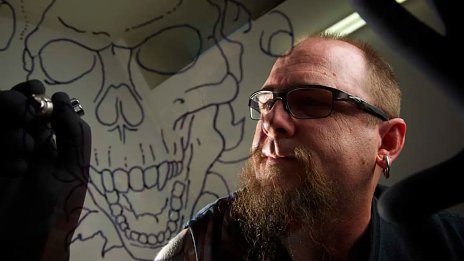 Artist Zach Tait, works on a tattoo at the Wicked Ink Tattoo and Body Piercing studio in Penrith.