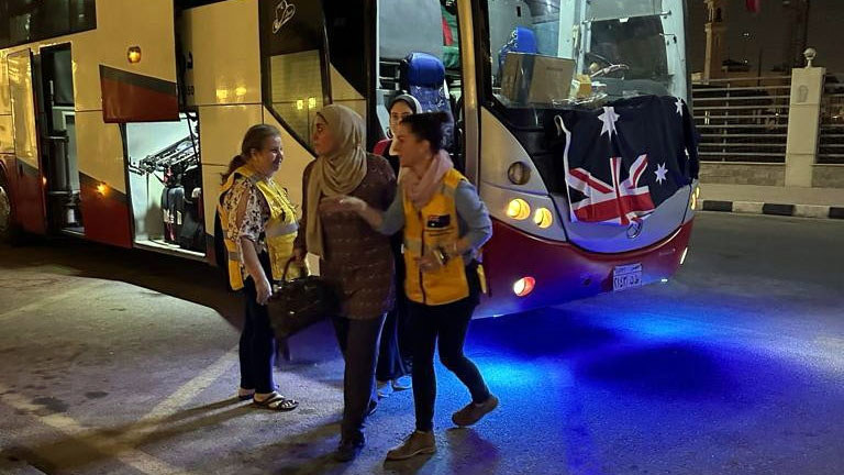 Australians leave a bus after crossing from Gaza to Egypt