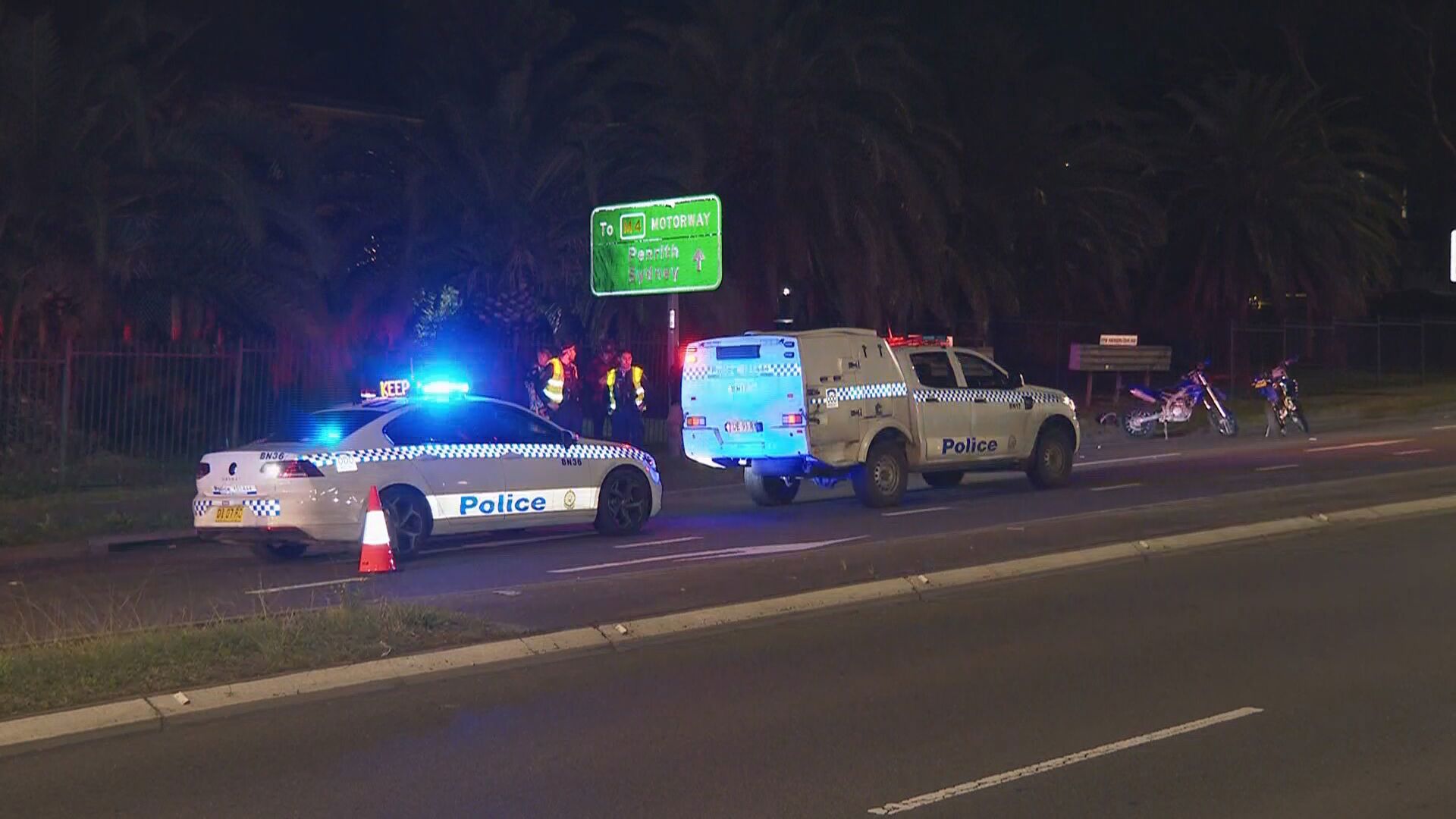 Police are searching for the driver of a white Mazda involved in an alleged road rage attack in western Sydney that has left a motorcycle rider seriously injured