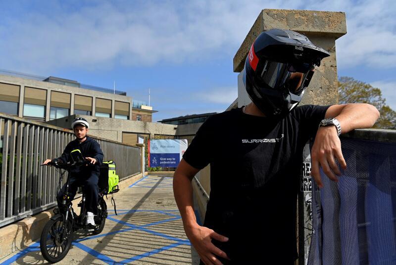 Stage name Sur Ronster an American content creator in his twenties specialising in electric bikes at Observatory Hill near the Sydney Harbour Bridge.