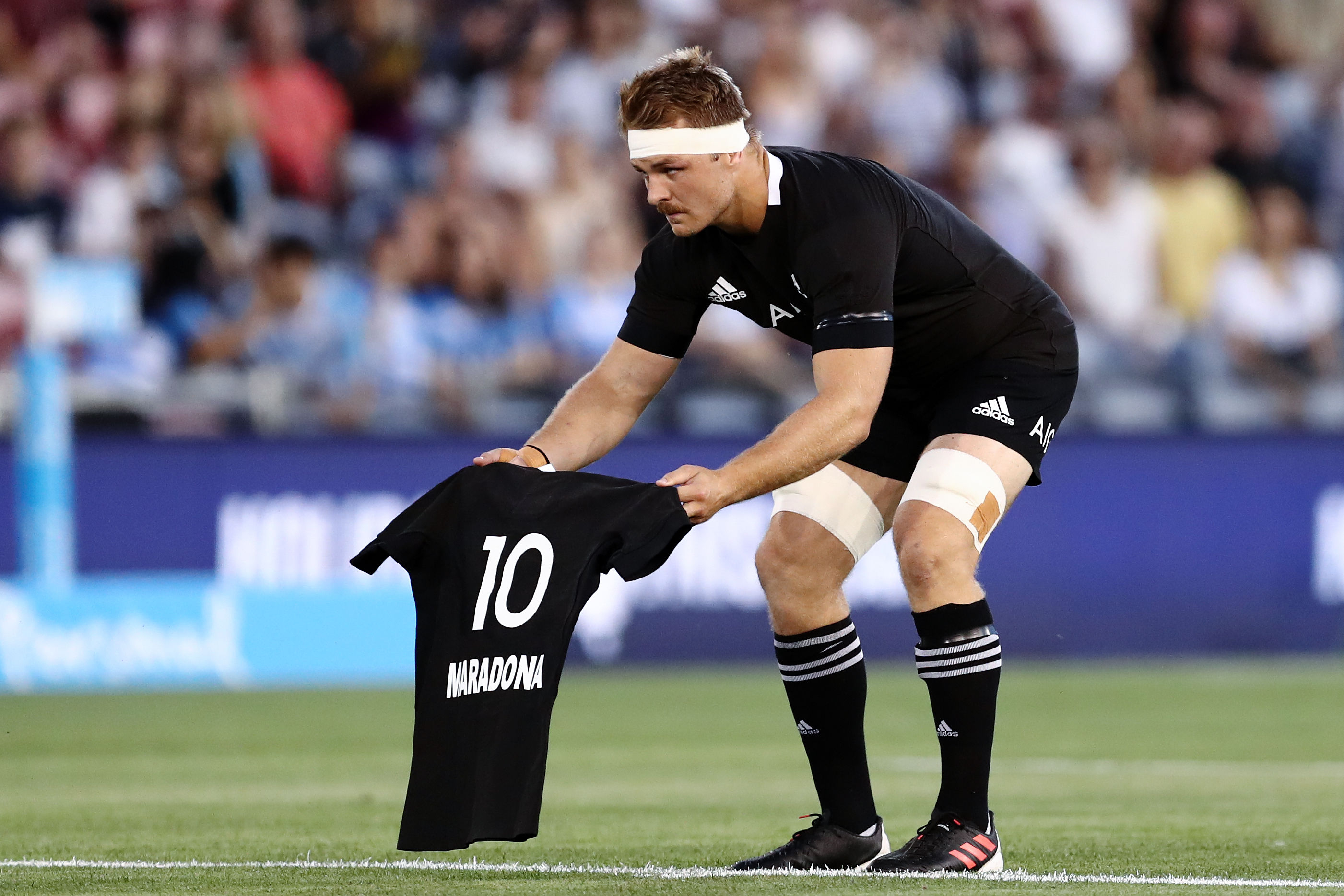 Sam Cane of the All Blacks lays down a number 10 jersey in memory of Diego Maradona.