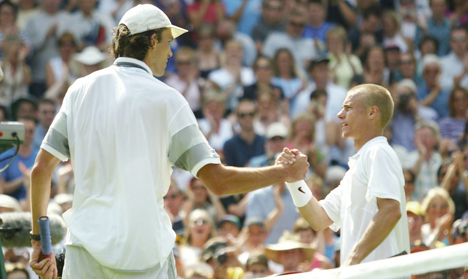 Ivo Karlovic and Lleyton Hewitt shakes hands after their famous 2003 Wimbeldon clash.