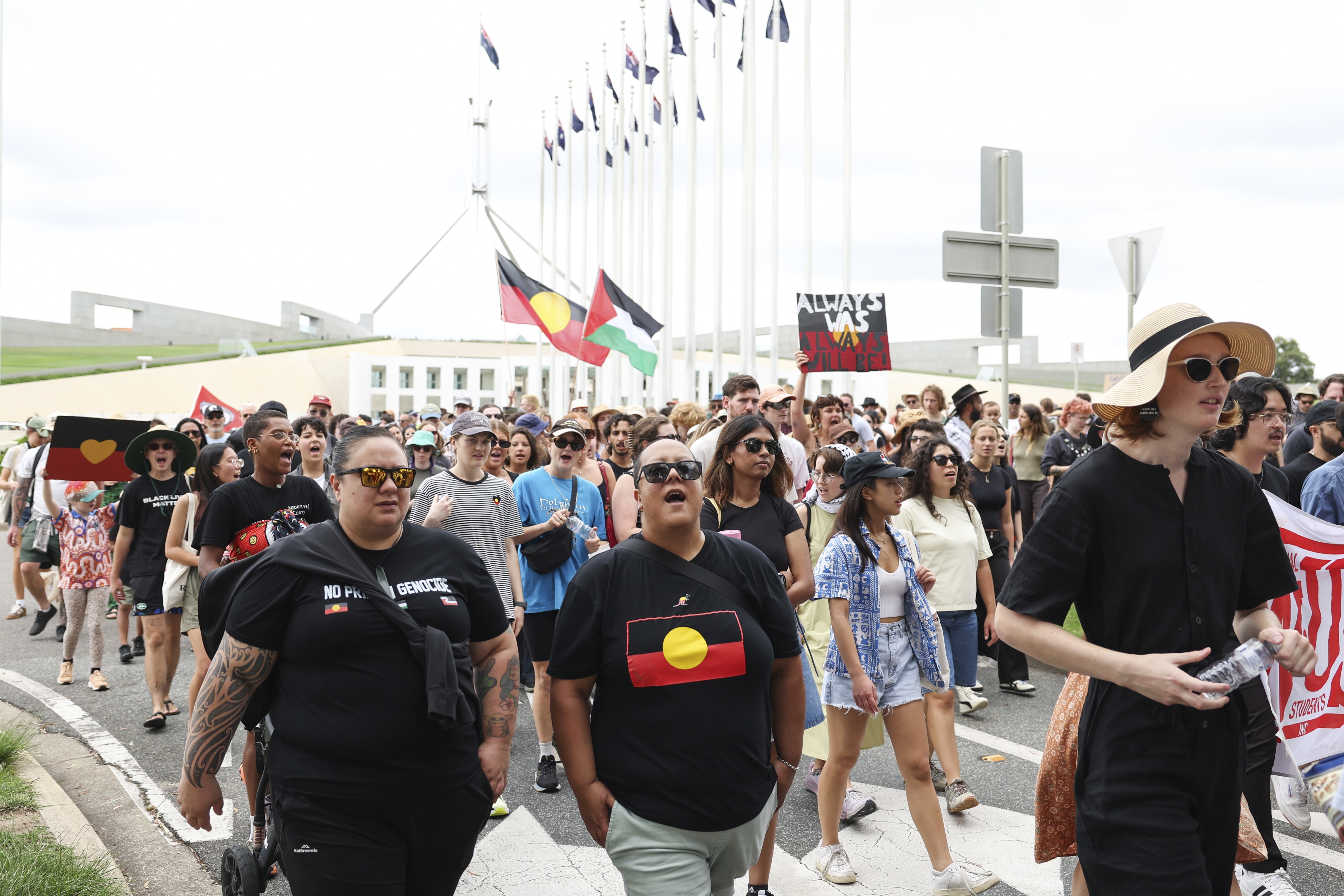 People march past Parliament House during the Sovereignty Day Rally in Canberra on Sunday 26 January 2025. fedpol Photo: Alex Ellinghausen