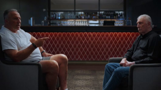 Ian Botham and Ian Chappell sit across from each other during filming for The Longest Feud.