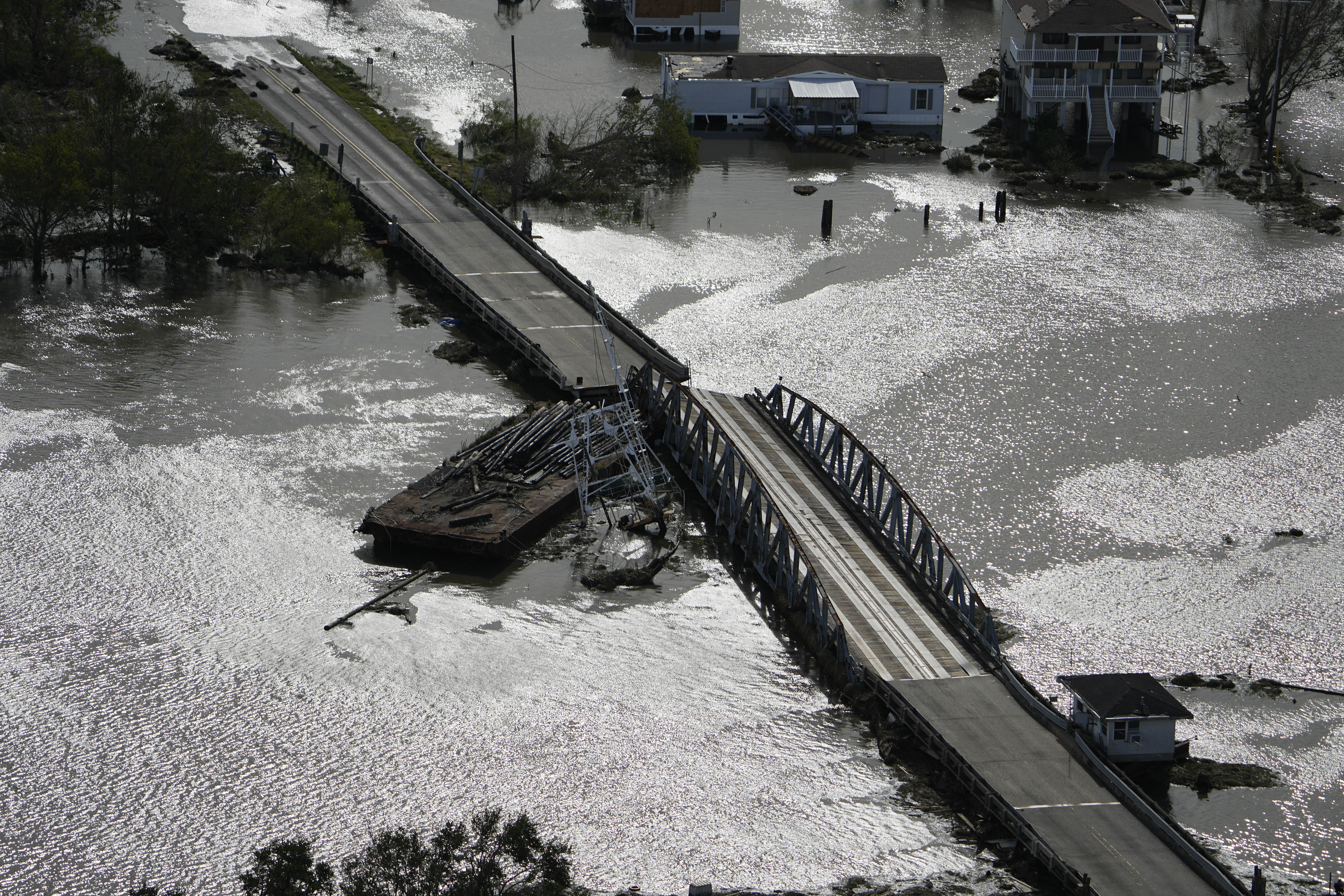 A barge damages a bridge that divides Lafitte, La., and Jean Lafitte, in the aftermath of Hurricane Ida, Monday, Aug. 30, 2021, in La. (AP Photo/David J. Phillip)