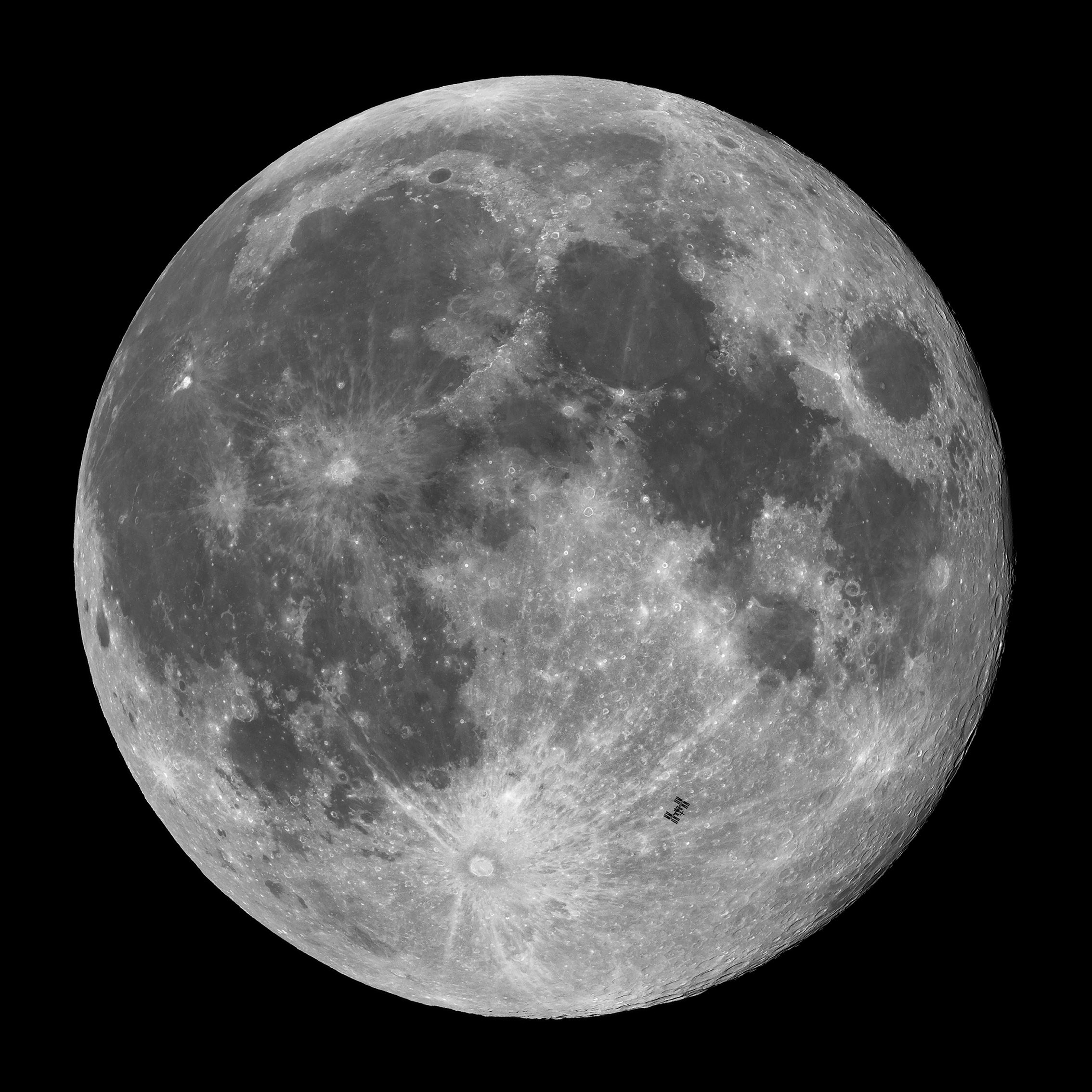 This image captures the International Space Station (ISS) in transit across October's Full Moon, the Hunter's Moon, approximately 12 hours after a partial lunar eclipse. The striking beauty of the Full Moon is on display, with its mix of rugged highlands, bright crater rays and darker maria. 