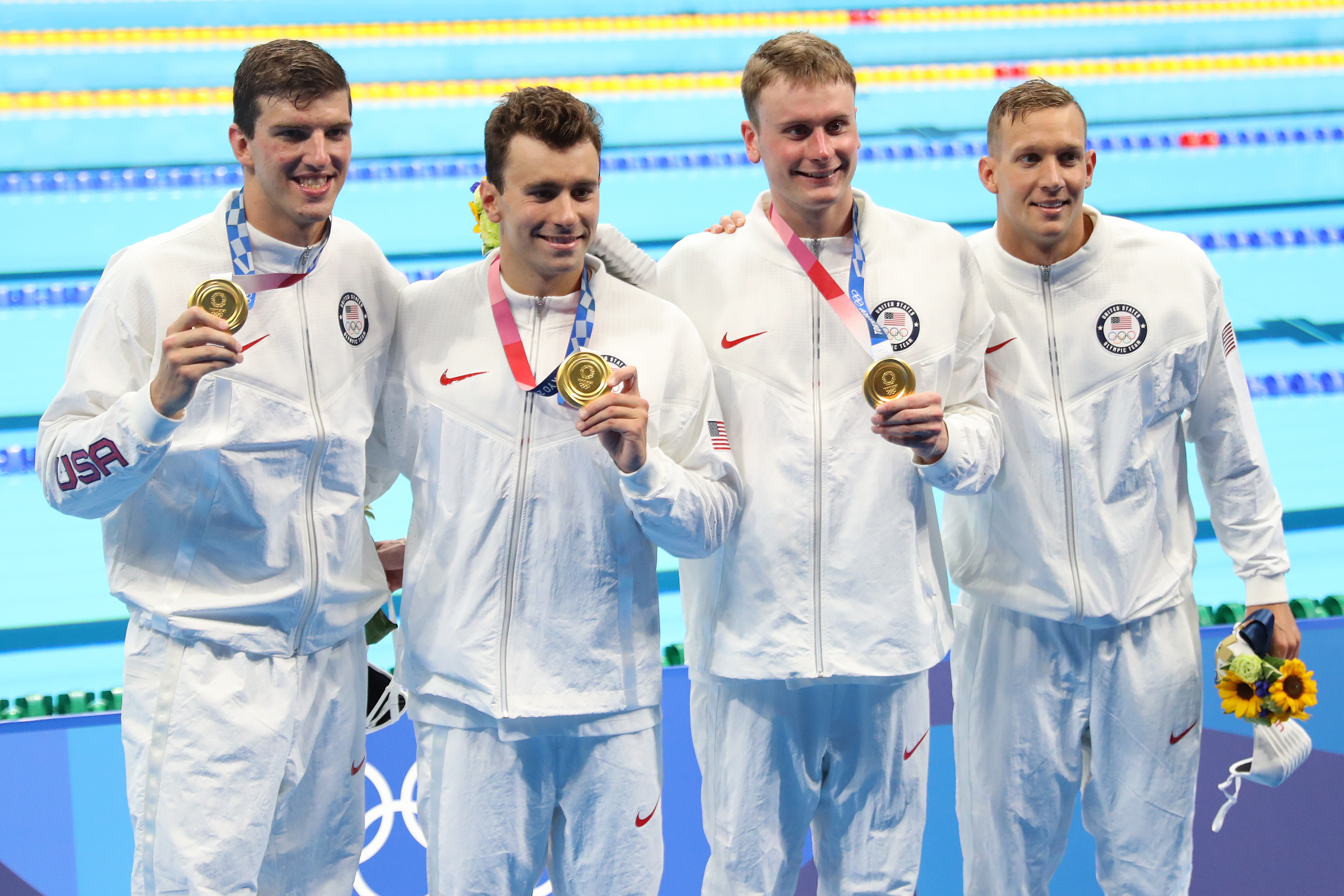 Zach Apple, Blake Pieroni, Bowen Becker and Caleb Dressel celebrate their relay win.